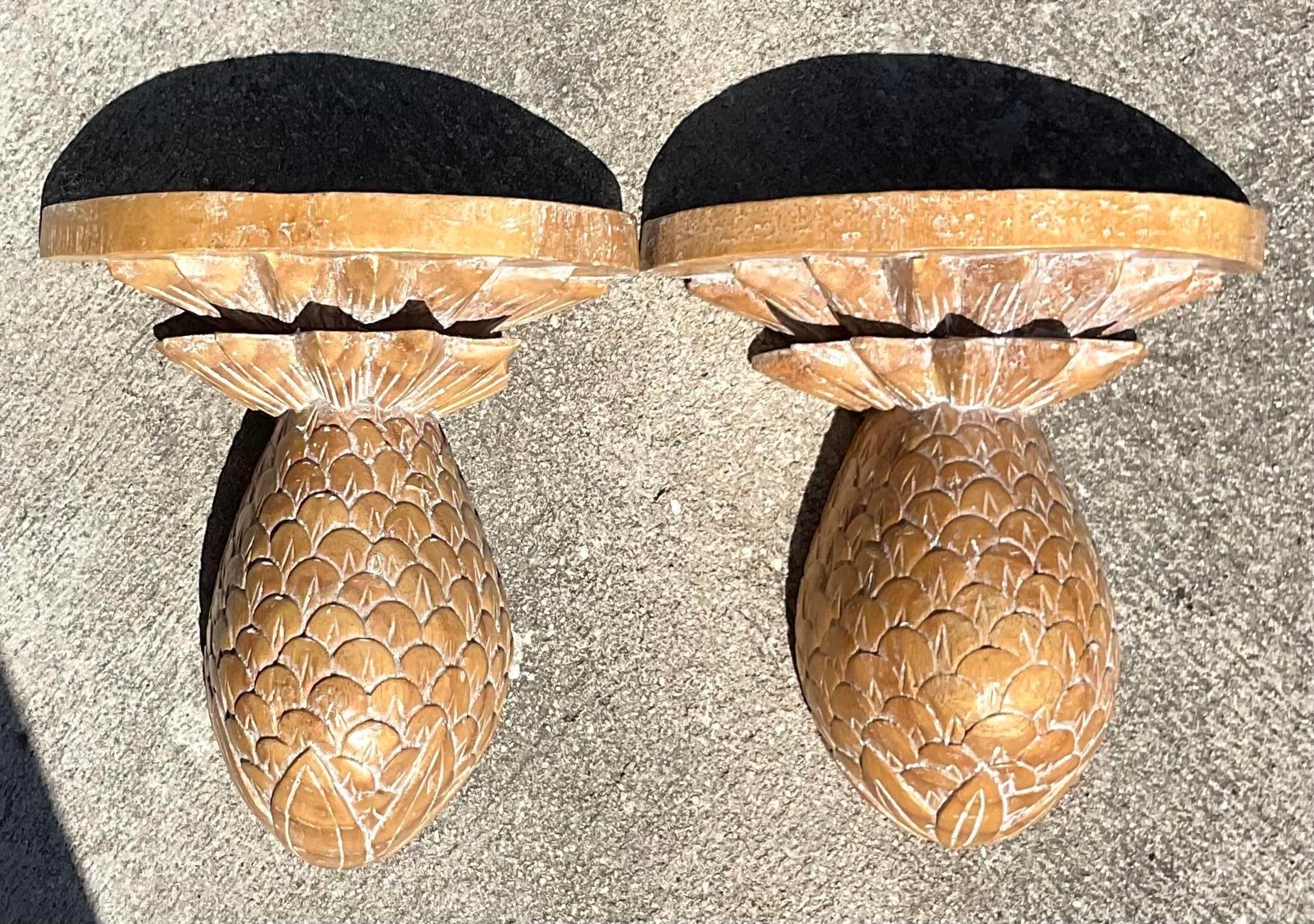 Add a touch of tropical elegance with this pair of vintage Regency washed wood pineapple brackets. American-crafted with intricate detailing, these brackets serve as both functional and decorative elements, bringing a hint of island-inspired charm