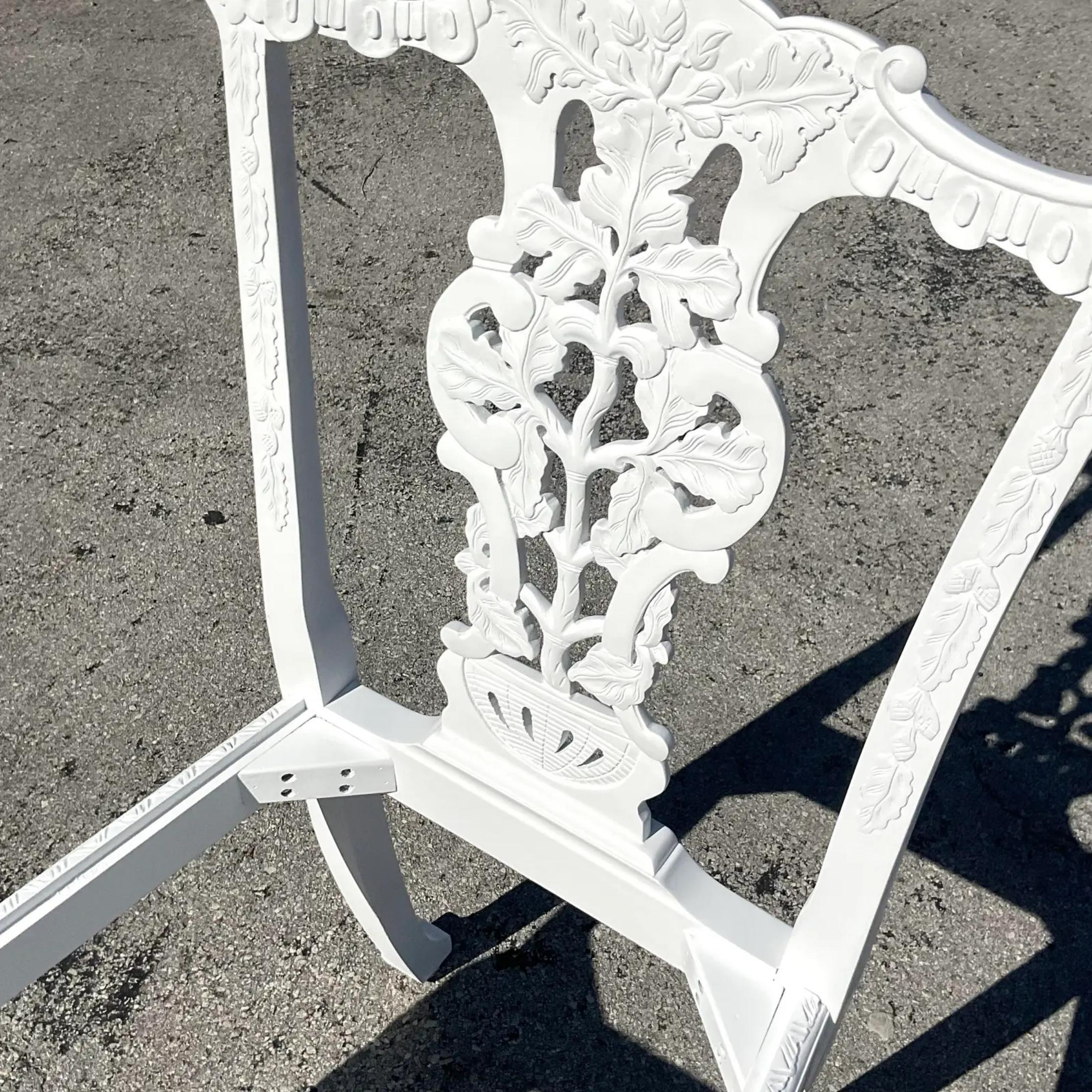 A fantastic pair of vintage Regency side Chippendale chairs. Beautiful hand carved detail on a ball and claw foot design. Painted a bright semi gloss white. No seats. Acquired from a Palm Beach estate.