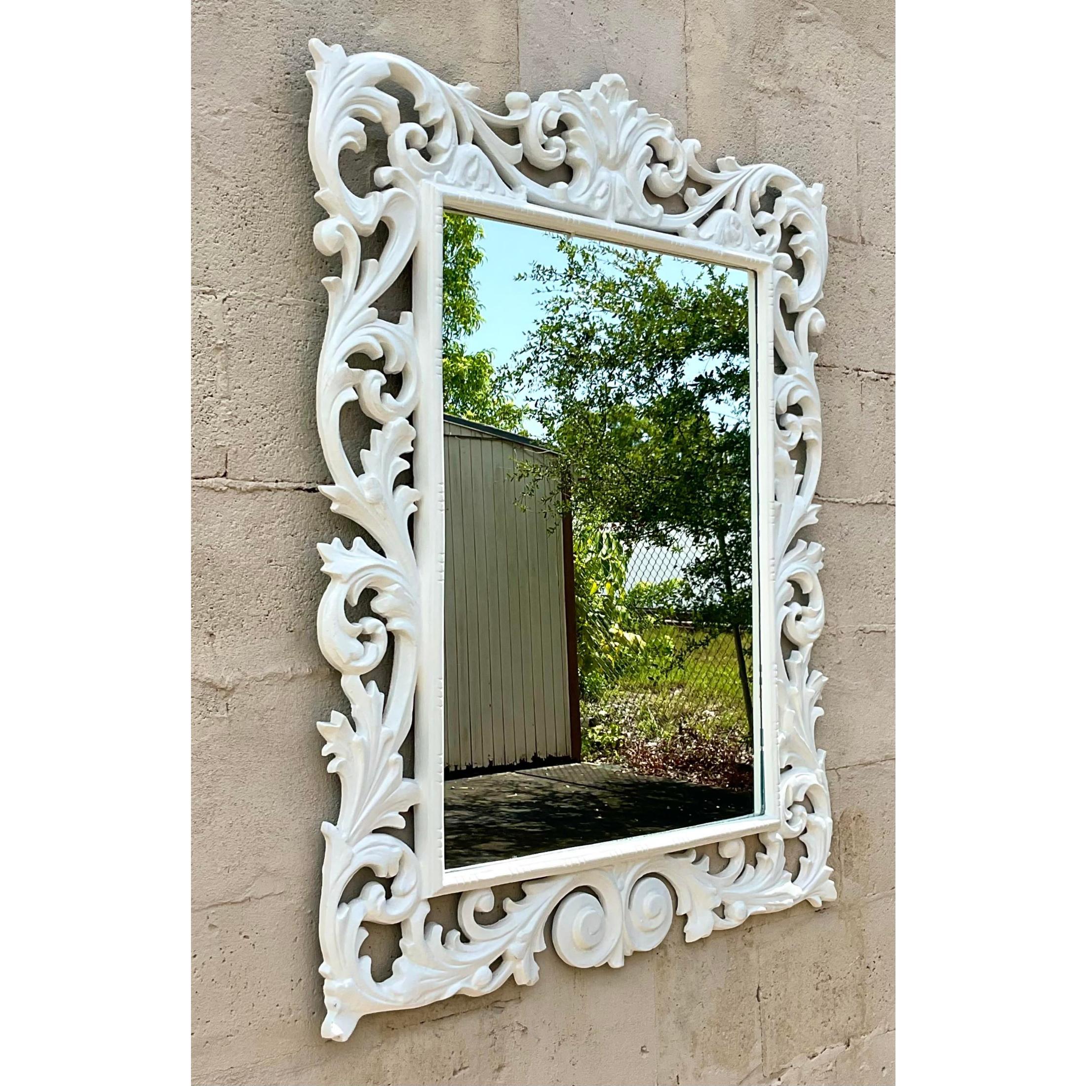 Fantastic vintage Regency mirror. Beautiful carved detail in a bright white lacquered finish. Acquired from a Palm Beach estate.