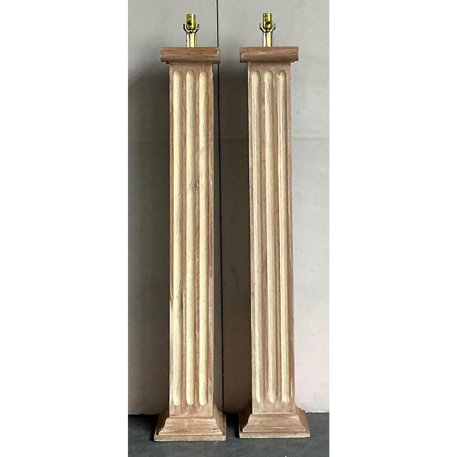 Make a grand statement with this stunning pair of vintage wooden floor lamps. Drawing inspiration from classical architecture, each lamp is meticulously carved in the form of a fluted Doric column, embodying the timeless principles of Neoclassical