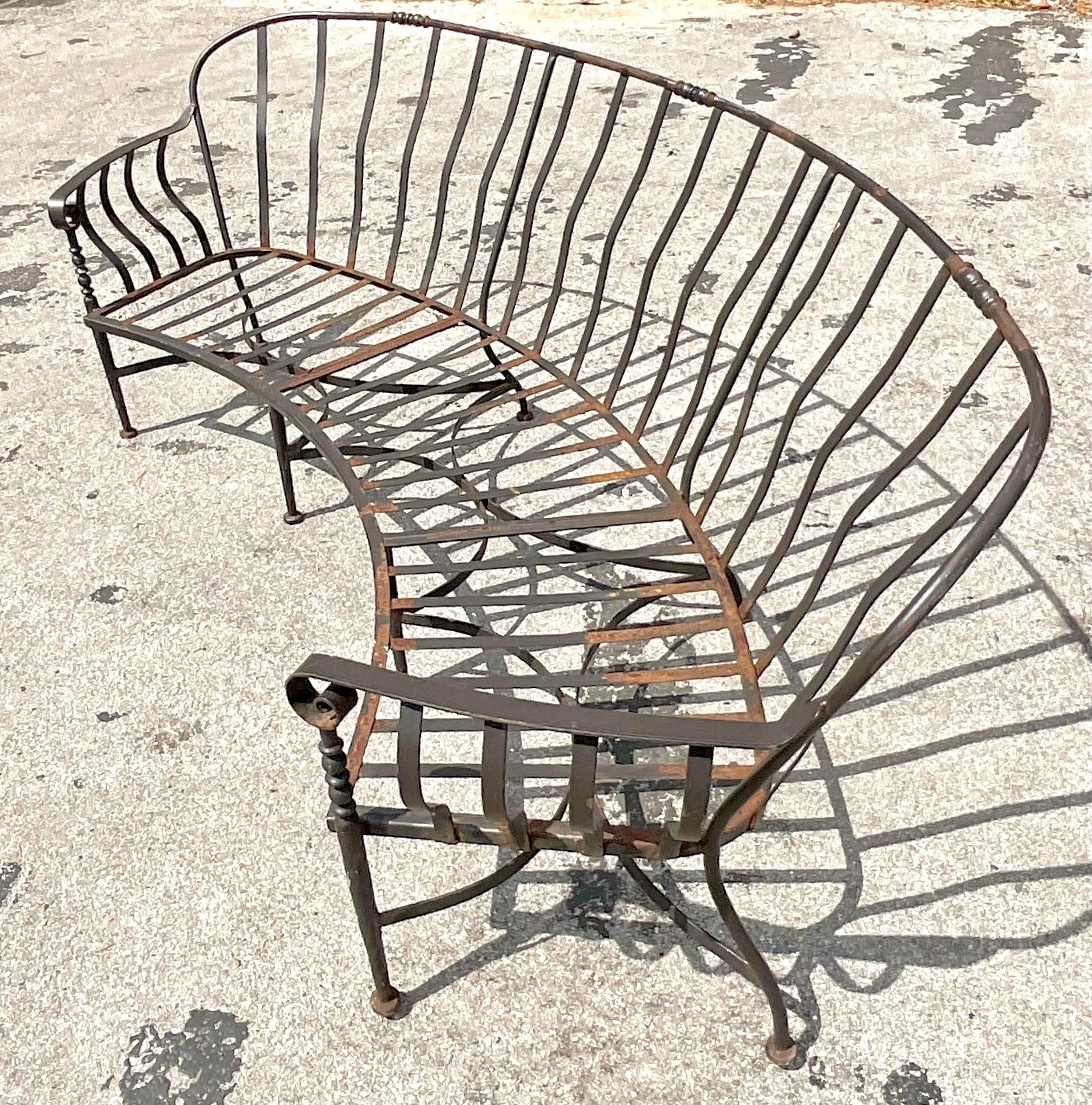 A fabulous vintage Regency wrought iron sofa. Beautiful curved shape with gorgeous detail iron work. Acquired from a Palm Beach estate.
