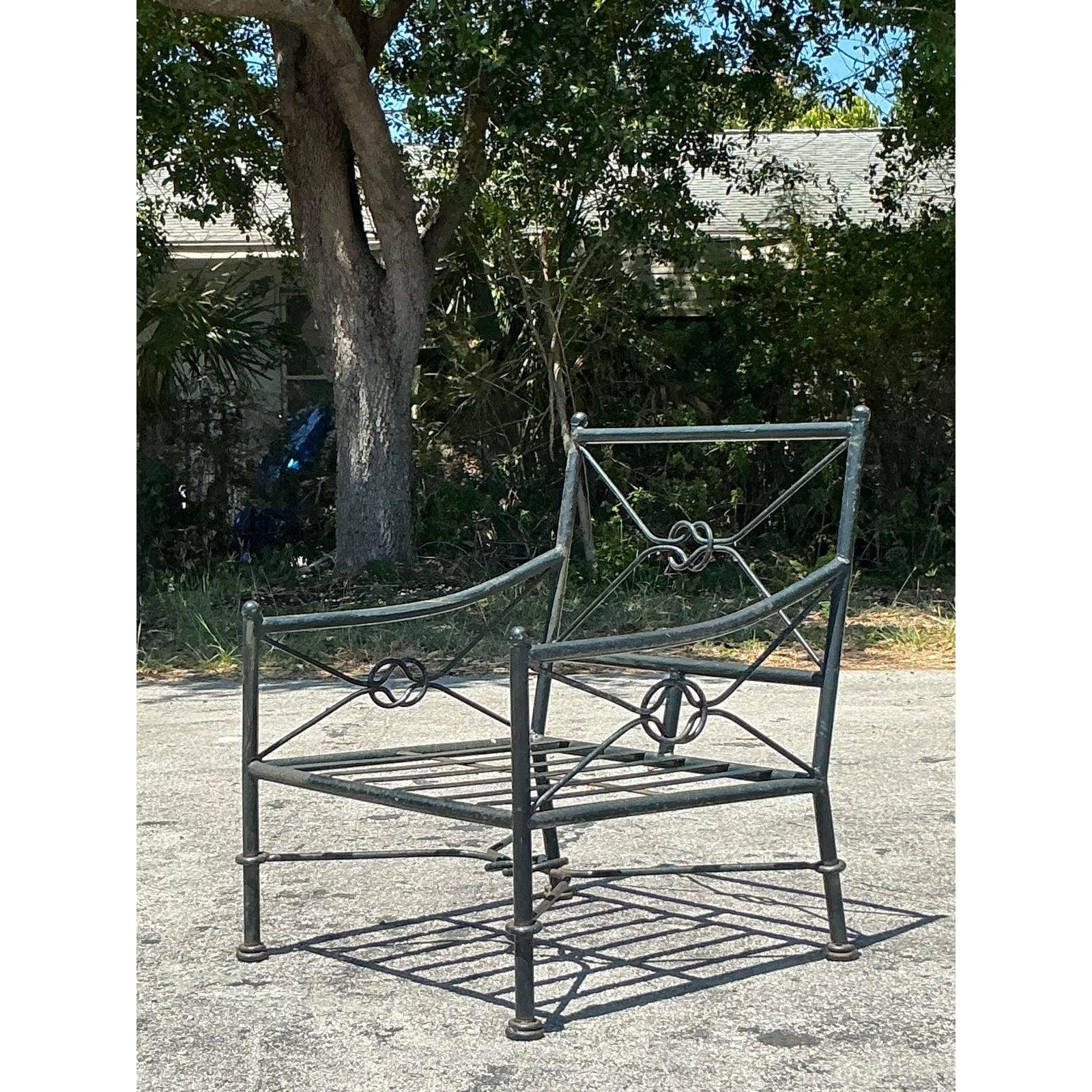 Relax in vintage style with this elegant Vintage Regency Wrought Iron Lounge Chair, a perfect blend of comfort and classic design. Crafted from durable wrought iron, this chair features a graceful frame and a distinctive backrest adorned with