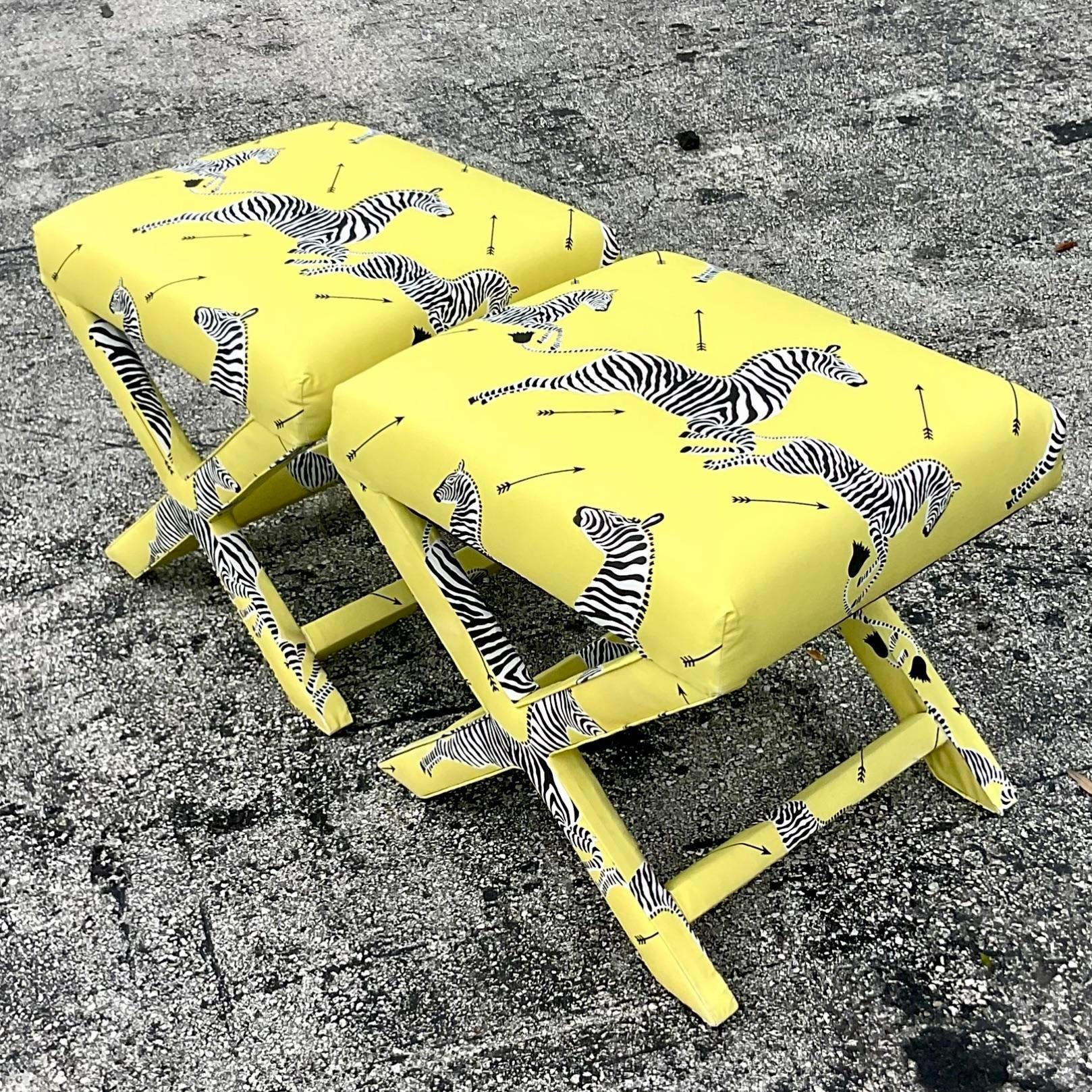 A stunning pair of vintage Regency X-benches. A classic shape upholstered in an homage to Scalamandre’s iconic Maasai print. Acquired from a Palm Beach estate.