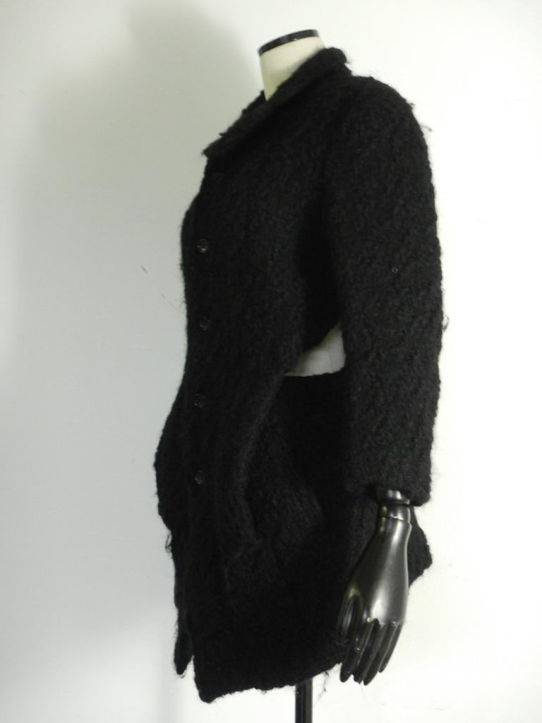This is a vintage Rei Kawakubo black wool coat, wonderful avant garde design.

The coat has no size marking, 100% wool, made in Japan.

This is in very good pre-owned condition with no stains, no structural defects.

MEASUREMENTS: (taken