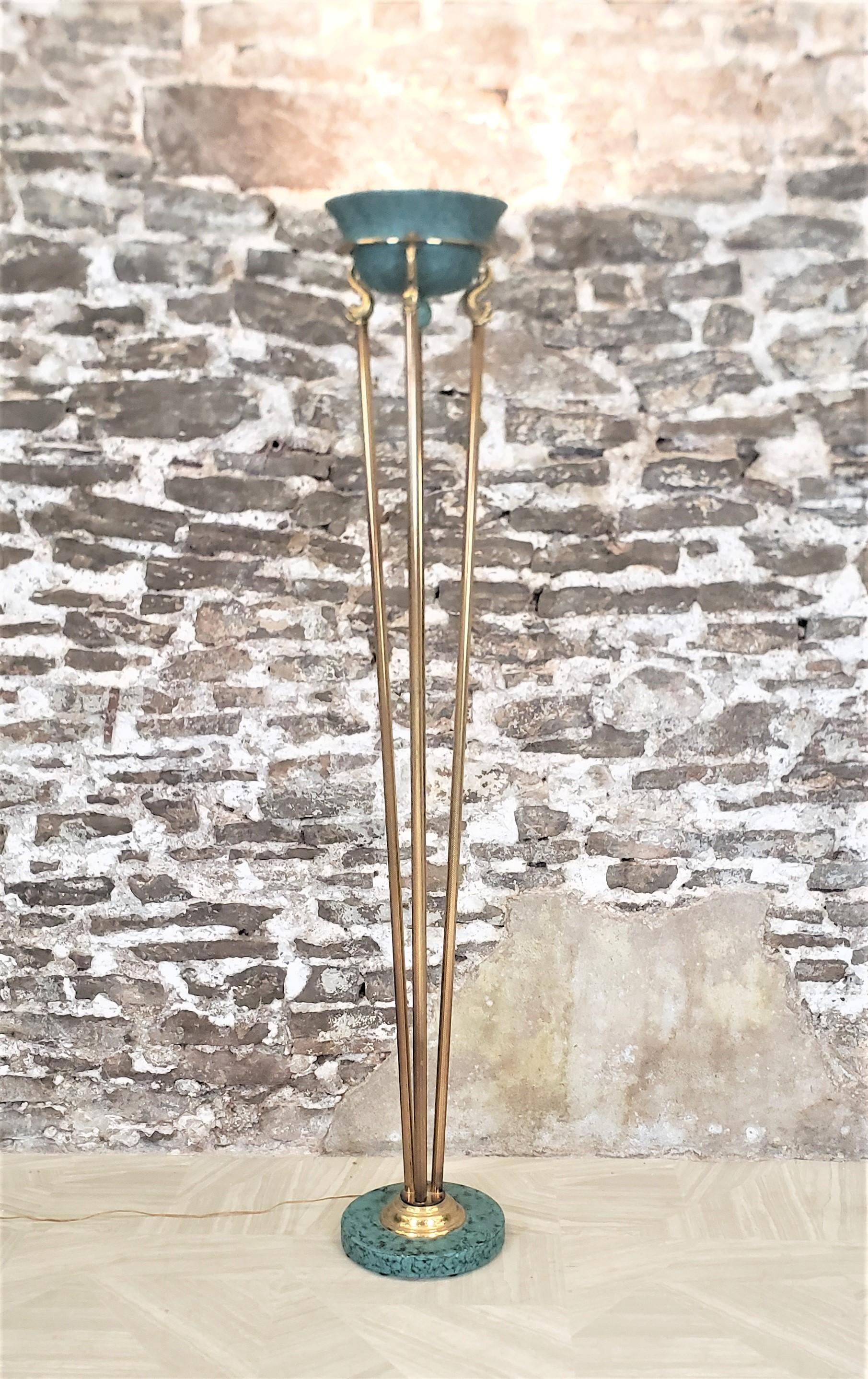 This vintage tortiere floor lamp was made by Relco Milano of Italy in approximately 1990 and marketed by the Design Institute of America and done in a Hollywood Regency style. This halogen lamp is done in knurled brass tubing, accented with a copper