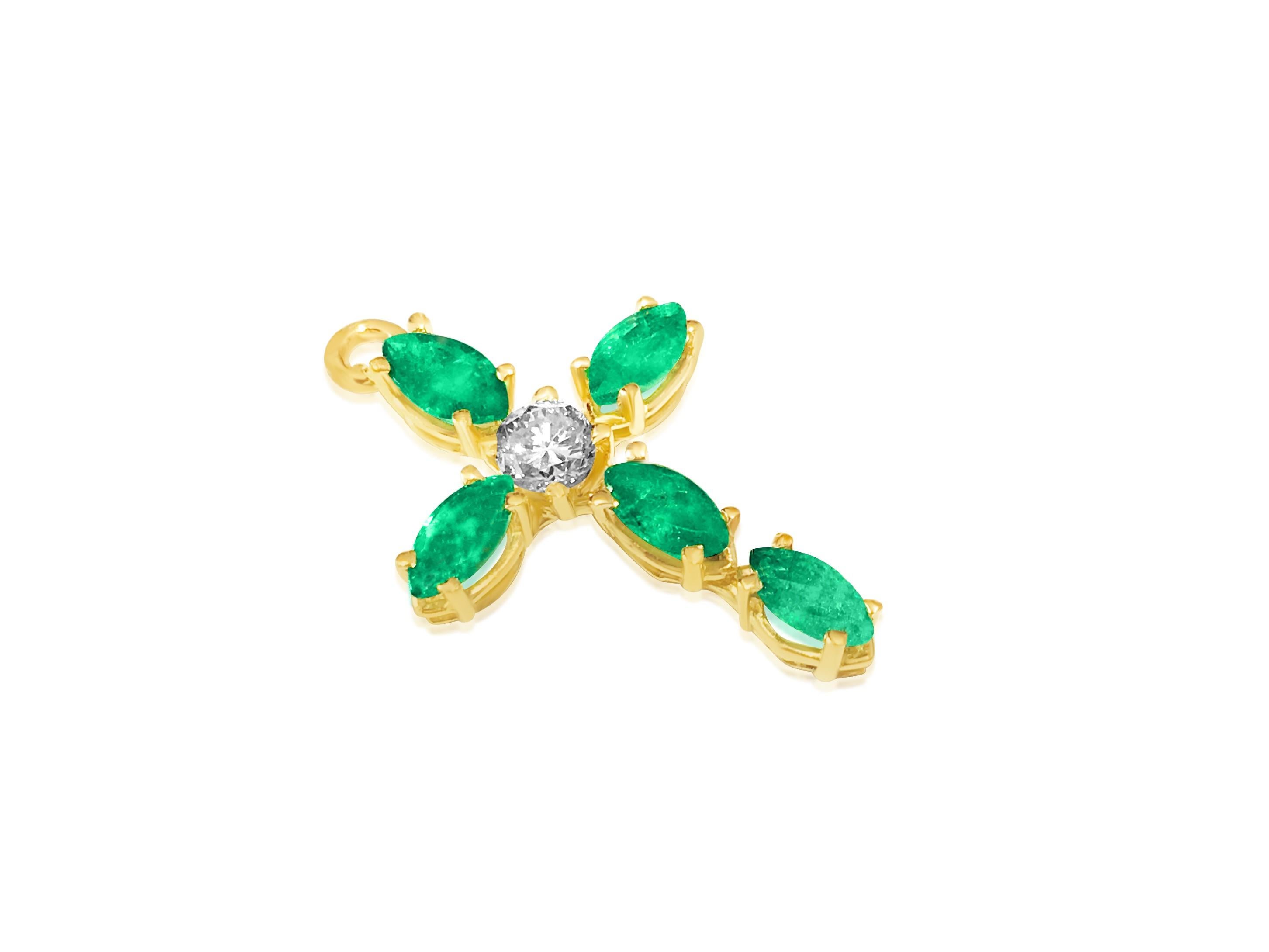 Presenting a stunning pendant cross crafted from 14k yellow gold, adorned with a 0.35 carat round brilliant-cut diamond and 0.60 carats of marquise-cut emeralds, all 100% natural earth mined and genuine. With SI1 clarity and G color for the diamond,