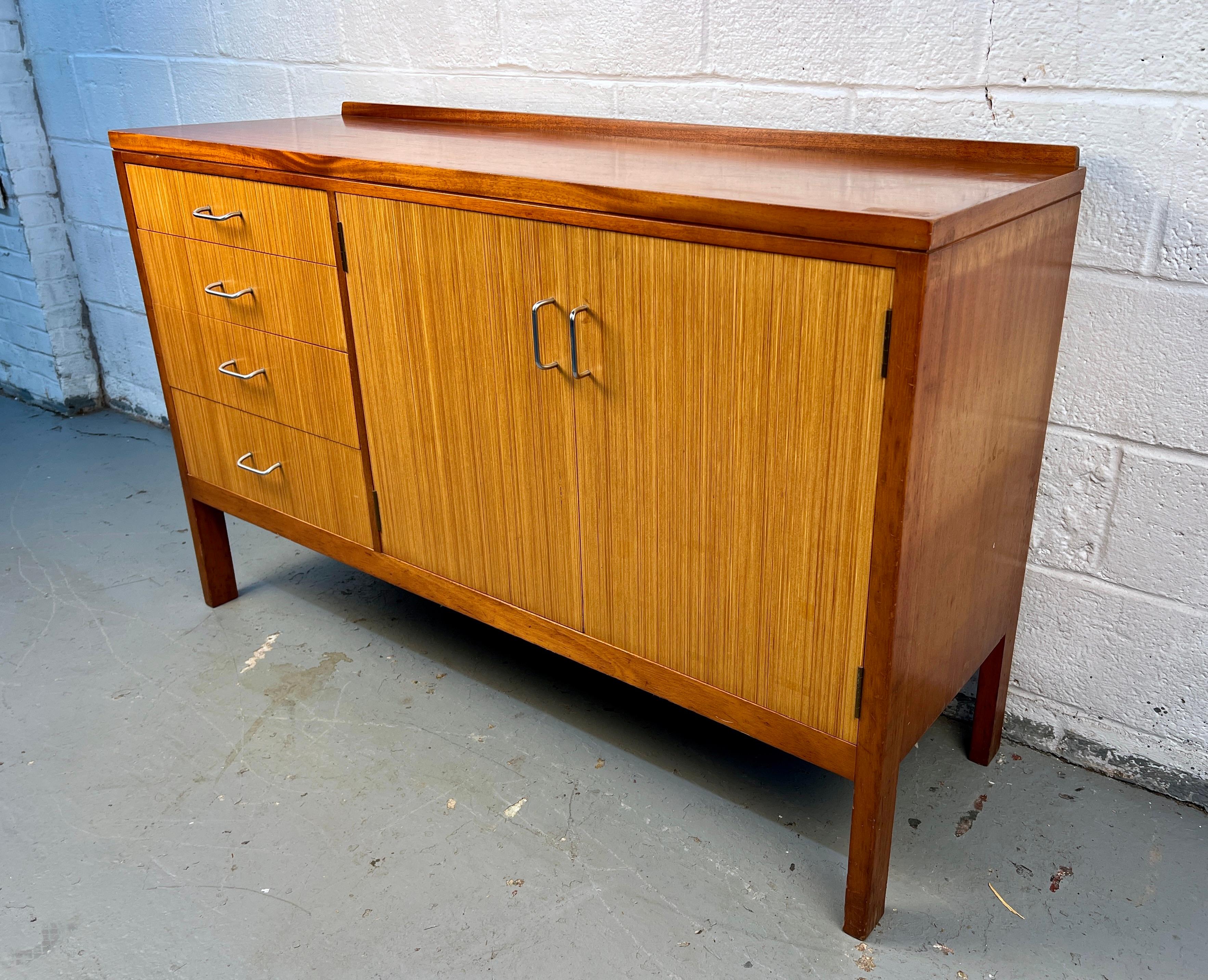 This simple sideboard was designed and manufactured by british firm remploy in the mid-twentieth century. Originally purposed for use in the british military accommodation complete with its original air council raf stamp ac arrow to the back panel.