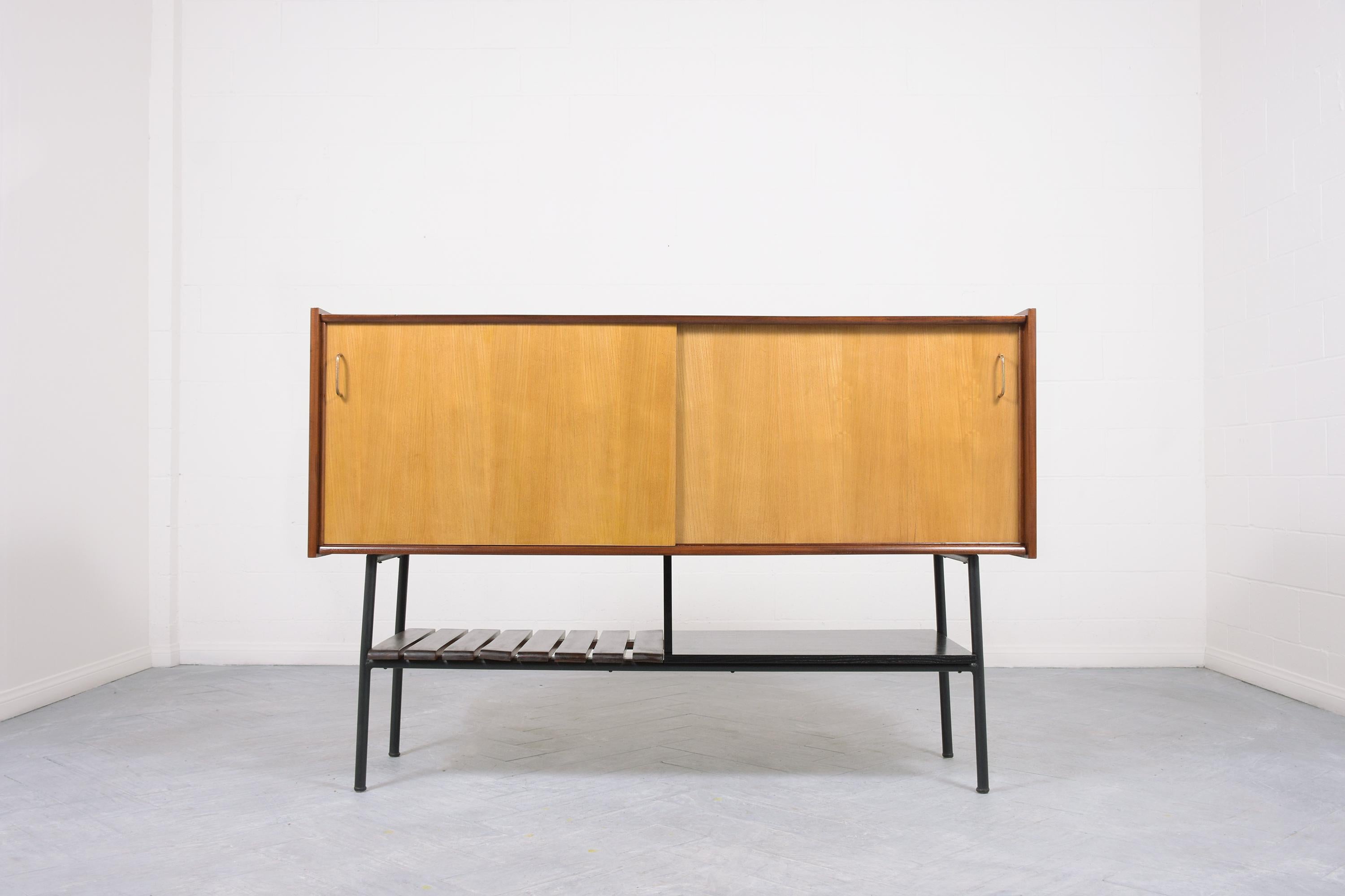 Step into a realm of vintage elegance with our French buffet, reminiscent of the celebrated style of René-Jean Caillette. Crafted with precision from rich mahogany and white oak wood, this mid-century modern credenza boasts great condition, having