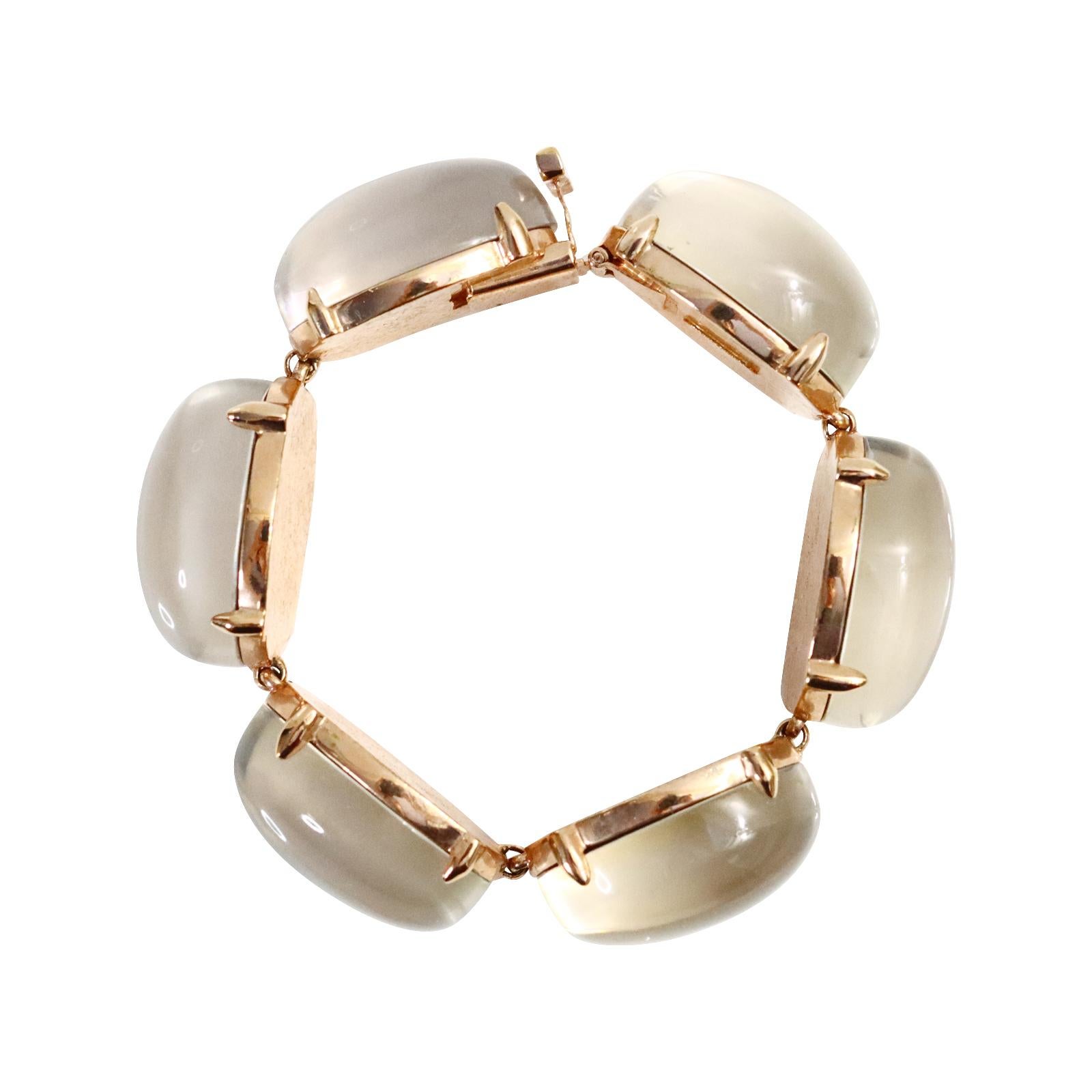 Vintage Replica Italy Rose Gold with Milky Gray Cabochon Circa 1990s.  I love this bracelet.  The chic simplicity of this is so La Dolce Vita.  This is heavy and substantial and prong set. The color varies and would probably vary dependent on what