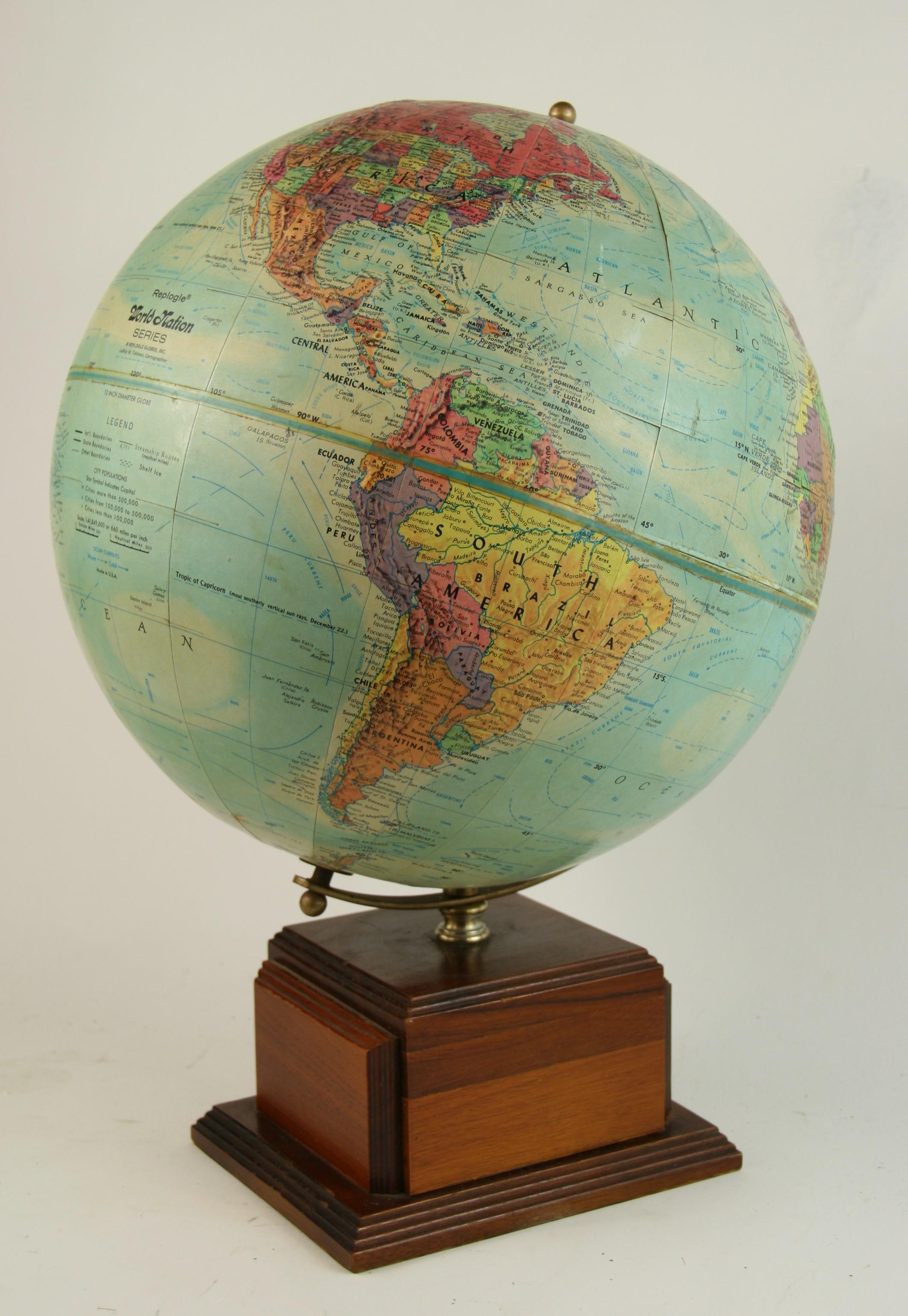 2-309 vintage world globe with raised surfaces set on a custom walnut wood stepped base, circa 1960.