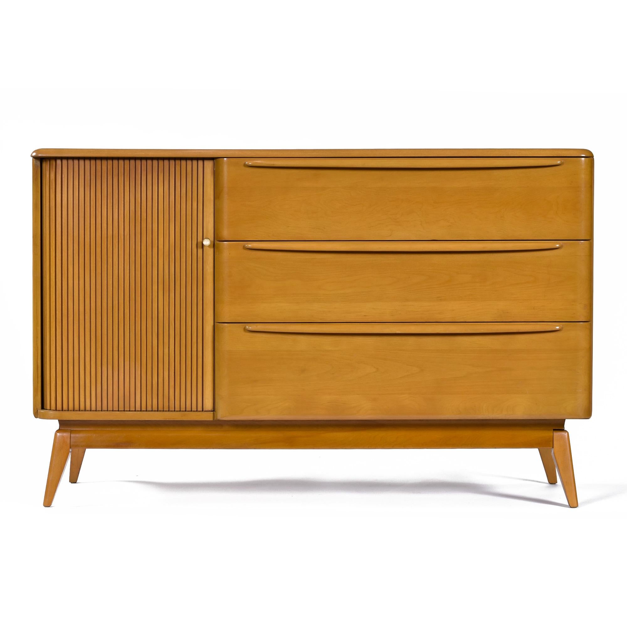 Versatility abounds with this Heywood Wakefield Model M-1542 Tambour Door Credenza.  Buffet, media cabinet, or entryway console are just a few ideas. As a dry bar, the adjustable / removable shelf will allow you to keep that whiskey collection cozy.