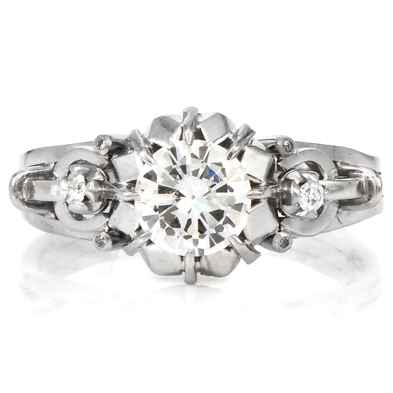 Vintage Retro Diamond Filigree Platinum Engagement Ring.

This ornately carved open work 1950s Diamond Engagement Ring was inspired with 

A floral motif crafted in Platinum.

Adorning the center is a Round Cut Diamond weighing. Approx. 1.02 carat
