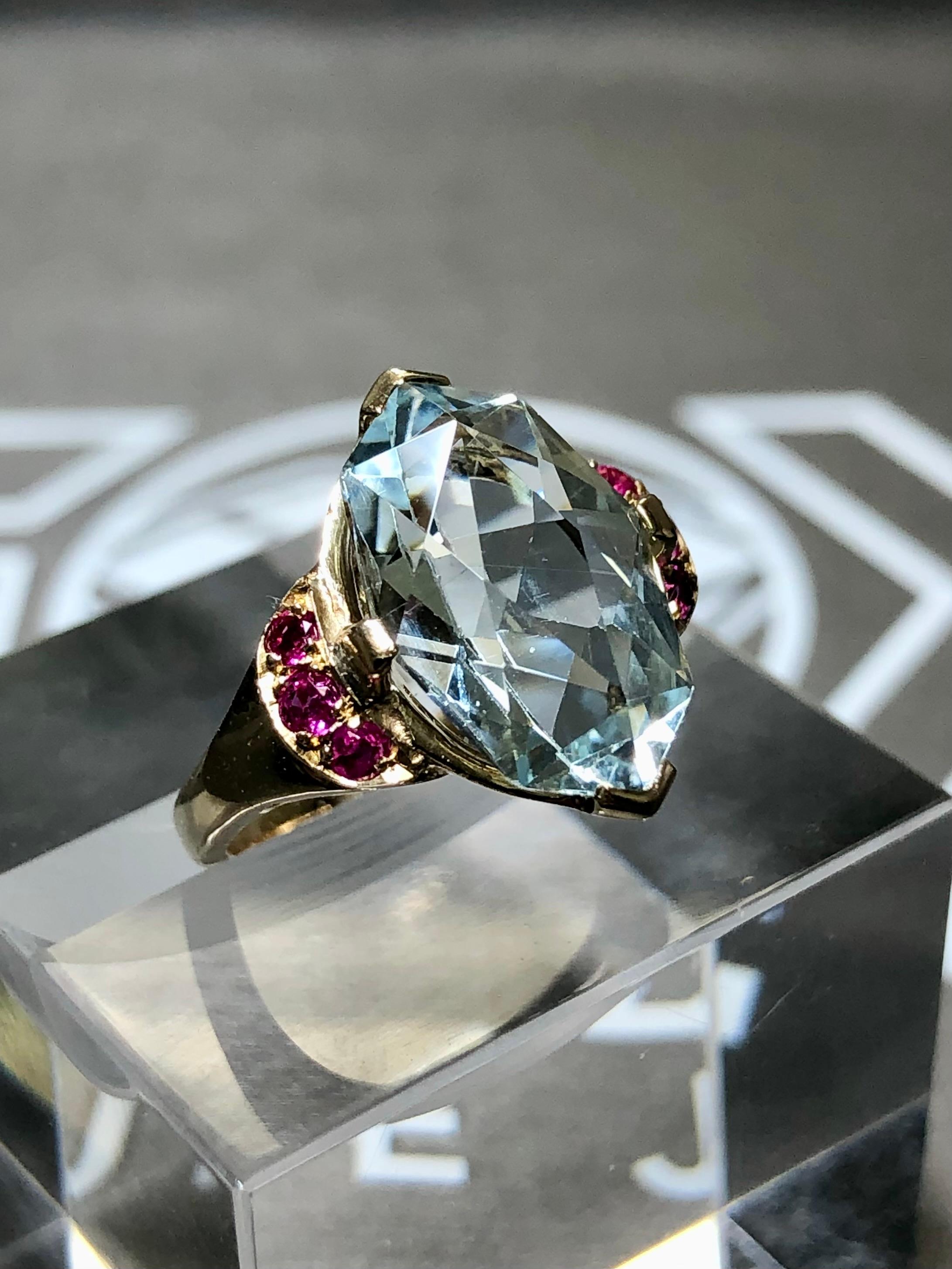 
A pretty little retro ring crafted in 14K rose gold and centered by an approximately 4.40ct uniquely cut marquise shaped aquamarine flanked by approximately .40cttw in natural, bright red rubies.


Dimensions/Weight:

Ring measures .60” by .50” and
