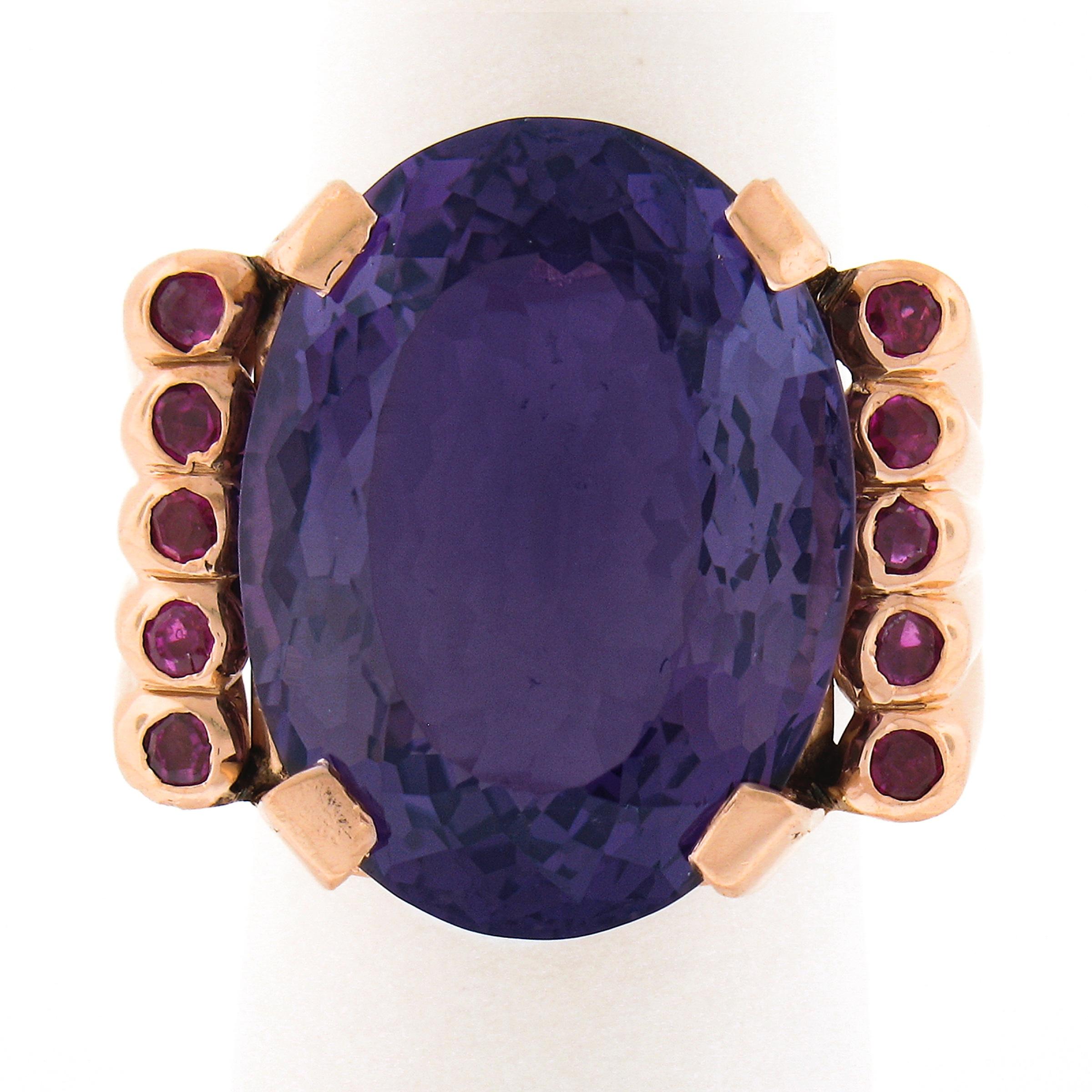 This magnificent vintage cocktail ring is crafted in solid 14k rose gold and features a gorgeous natural amethyst stone neatly prong set at its center. This large oval amethyst displays the most gorgeous and mesmerizing medium to dark purple color