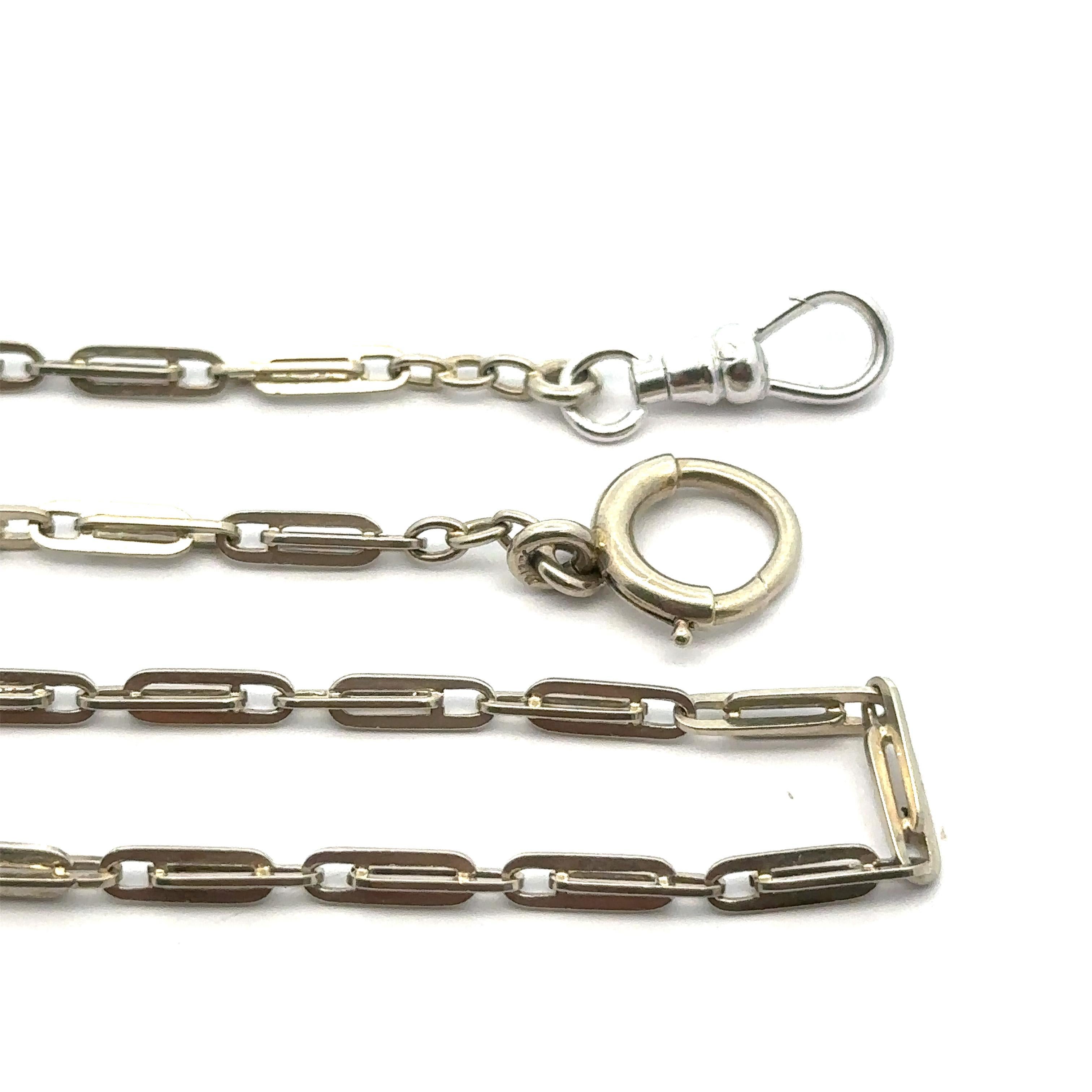 MATERIAL : Or blanc massif 14K
Poids : 8.8 grammes
Type de chaîne : Maillons ovales à emboîtement
Longueur de la chaîne : 15.5 pouces (mesurée à côté de la règle)
Épaisseur/largeur de la chaîne : 2,78 mm (au niveau des maillons)
Fermoir : anneau à