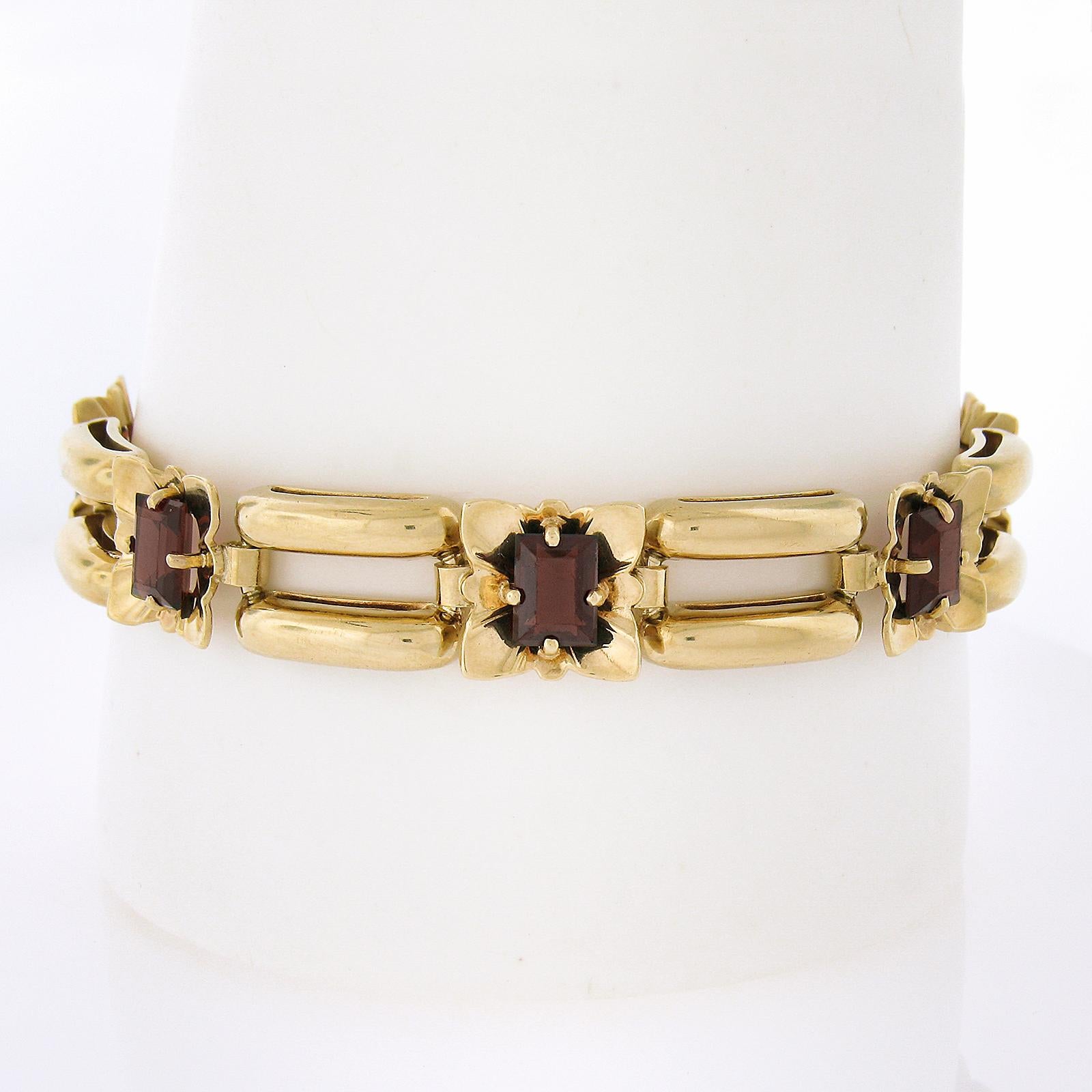 --Stone(s):--
(7) Natural Genuine Garnets - Rectangular Step Cut - Prong Set - Brownish Red Color - 7x5mm (approx. each) - 8-10ctw (approx.)

Material: Solid 14k Yellow Gold
Weight: 29.41 Grams
Chain Type: Floral & Dual Row Puffed Open Tubes Shape