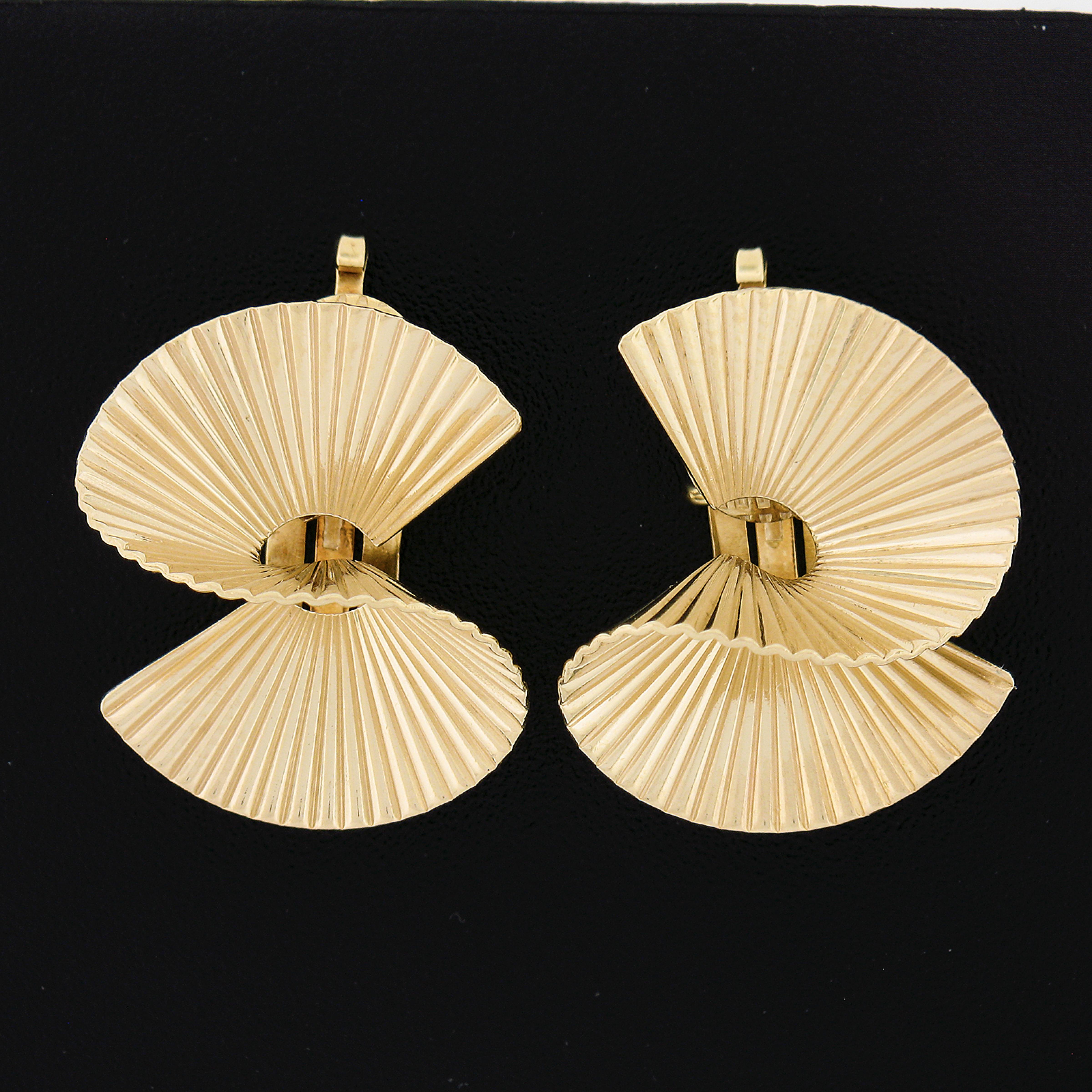 Here we have a gorgeous pair of vintage earrings that are crafted in solid 14k yellow gold. They feature a lovely twisted design with an elegant grooved/fluted pattern throughout that give the pair its unique and attractive look, and they also