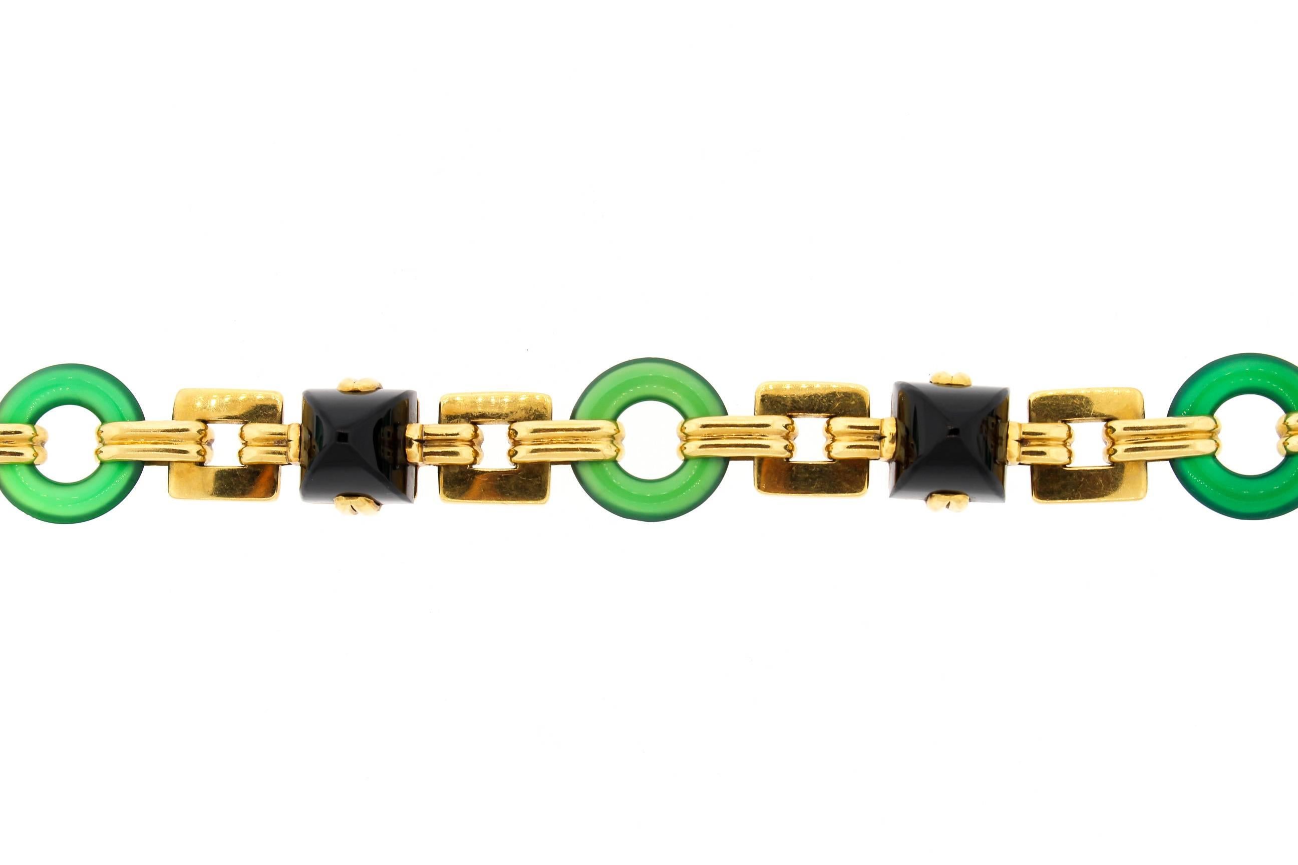 A solid and bold 18k gold Retro era bracelet set with alternating gold links, round chrysoprase and sugarloaf onyx sections.  The bracelet also features a handsome pattern of alternating square and round links.  Sometimes these bracelets are