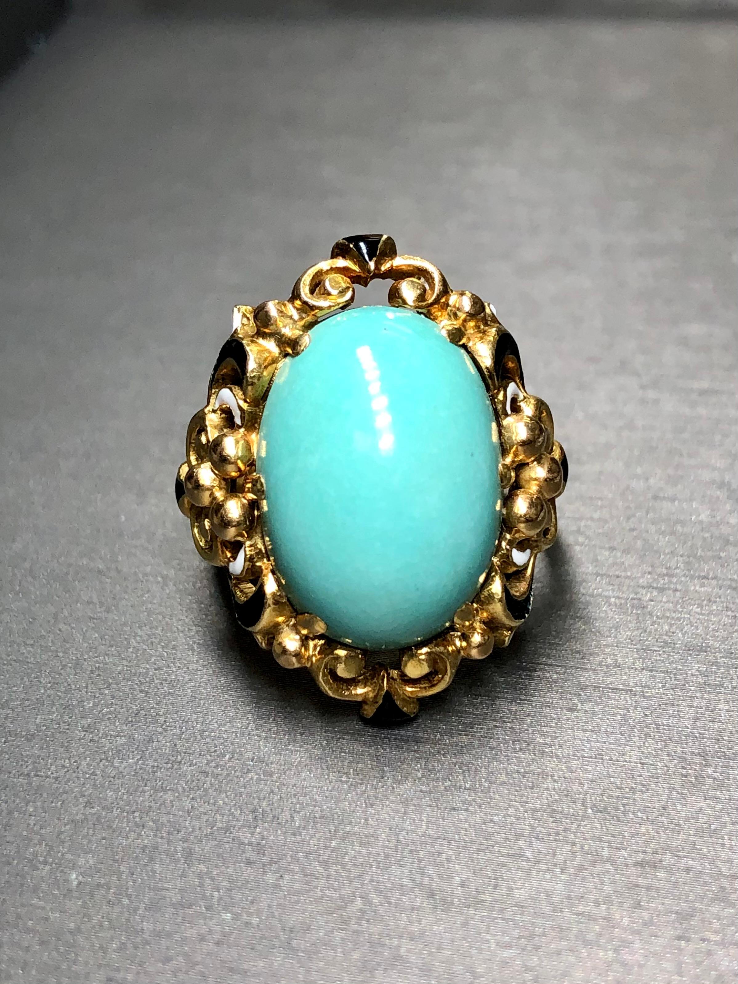 
A beautiful cocktail ring c. the 1950’s done in 18K yellow gold and finished with intricately laid black and white enamel and centered by cabochon natural turquoise (18.15mm x 13mm x 8.16mm. A clean design and all