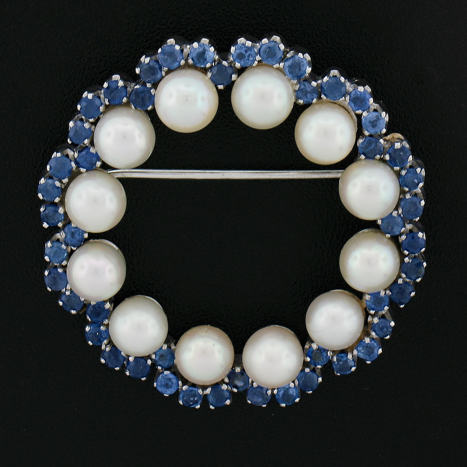 --Stone(s):--
(50) Natural Genuine Sapphires - Old Round Cut - Prong Set - Cornflower Velvety Blue Color - 1.50ctw (approx.)
(9) Genuine Cultured Akoya Pearls - Round Shape - Stem Set - White w/ Pink Overtone Color - Excellent Luster - 5mm each