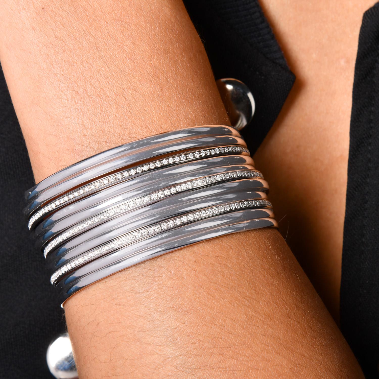 These fun bracelets are perfect for layering and stacking. They are Vintage Italian Retro 1980s stackable bangle bracelets crafted in solid 18-karat White gold and measure 6.75 inches around the wrist. They are composed of eleven gold bangles( 3