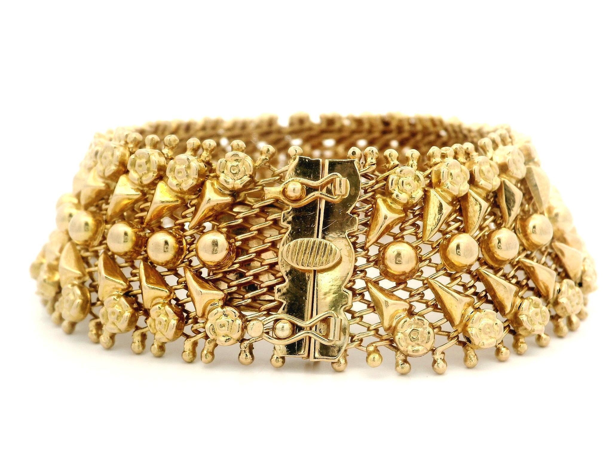 Material: Solid 18k Yellow Gold
Weight: 43.4 Grams
Bracelet Type: Repousse foliage work strap
Bracelet Length: Will comfortably fit up to a 7 Inch wrist (Fitted on a wrist)
Closure: Push clasp w/ dual safety latch
Width: 23.31mm (0.91