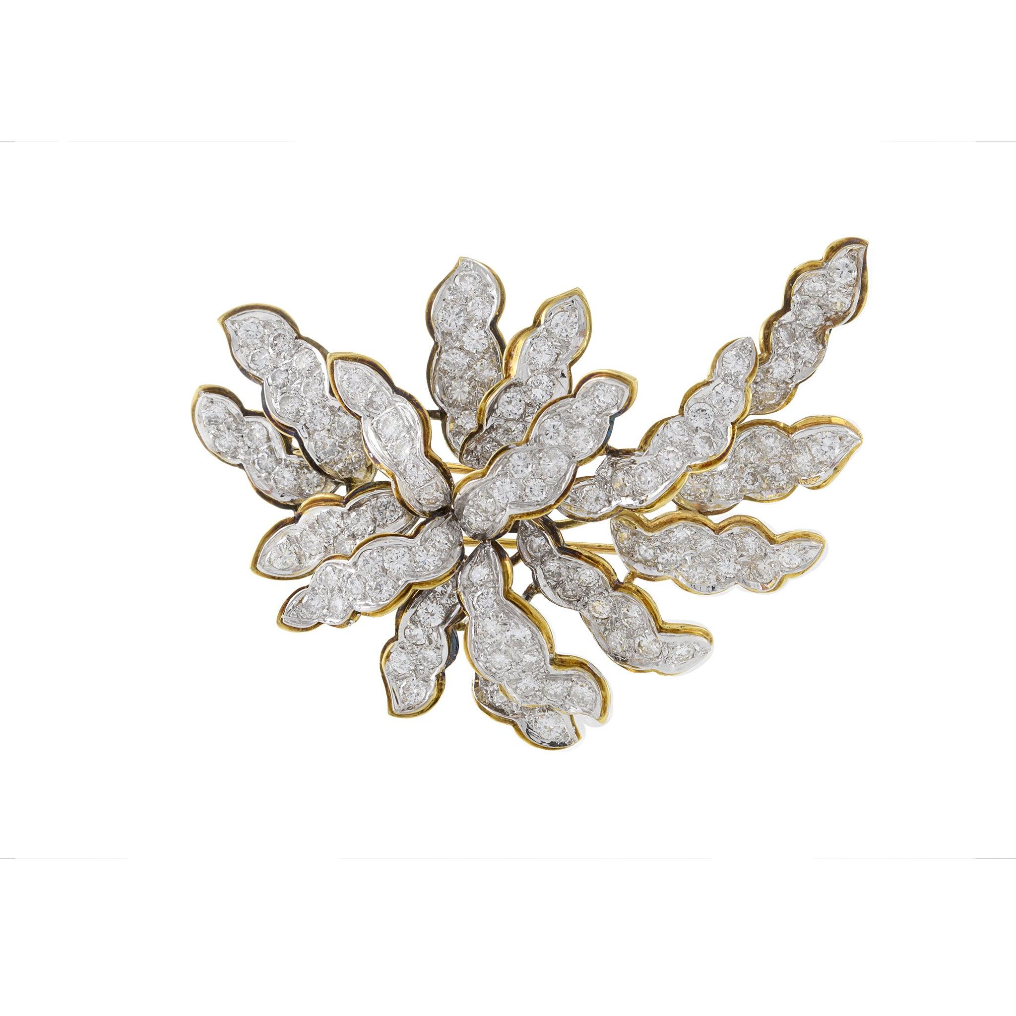 Embrace the timeless elegance of vintage design with our Large Floral Diamond Brooch, exquisitely crafted in 18KT yellow gold. This remarkable piece features a stunning array of diamonds totaling 8.00ct, each with a G color grade and VS clarity,