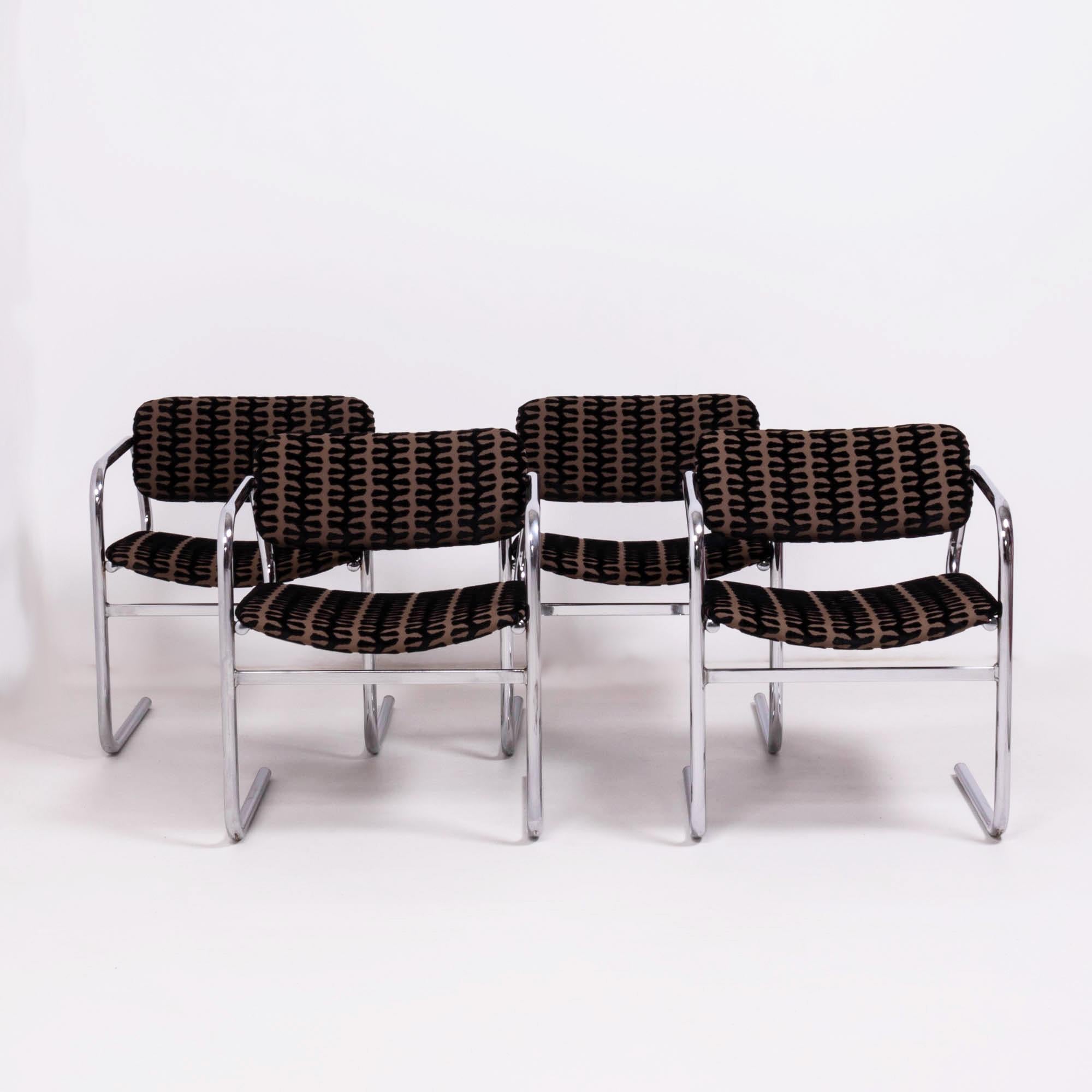 Designed and made by British furniture house Pieff, this set of four dining chairs is a fantastic example of Classic 1970s design.

Featuring chrome cantilever frames, the chairs have been newly reupholstered in black and brown flocked velvet
