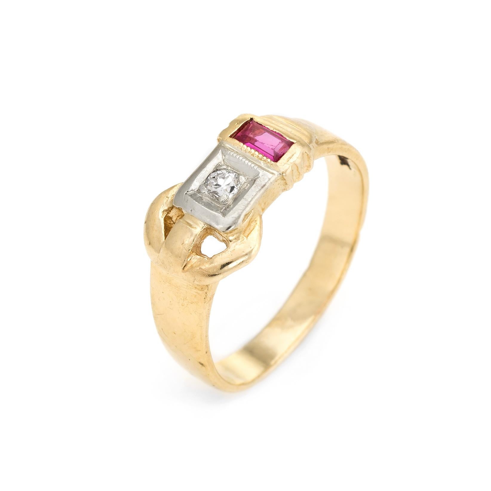 Distinct & stylish buckle ring (circa 1940s), crafted in 14 karat yellow gold. 

Center set old European cut diamond is estimated at 0.03 carats (estimated at J-K color and I1 clarity). The ruby accent (synthetic) is estimated at 0.05 carats. 

The
