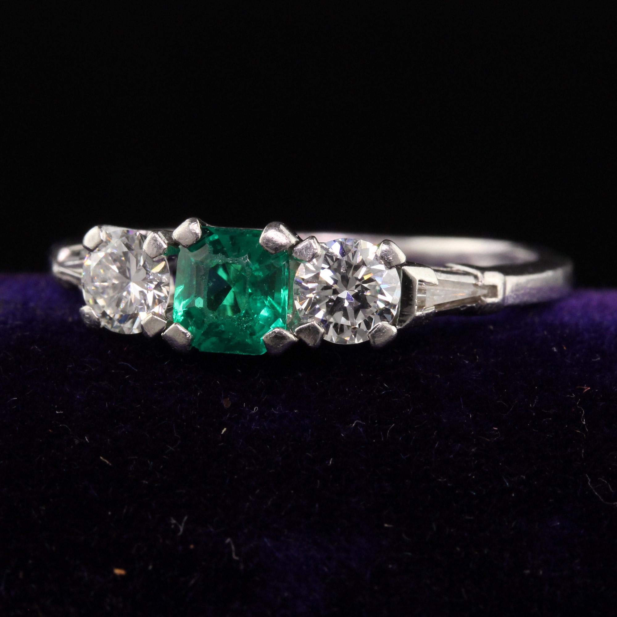 Beautiful Retro Vintage Peacock Platinum Diamond and Emerald Three Stone Ring. This beautiful band was made by C.D Peacock in the 1950's/60s and it is crafted in platinum with transitional cut diamonds on either side of a glowing green
