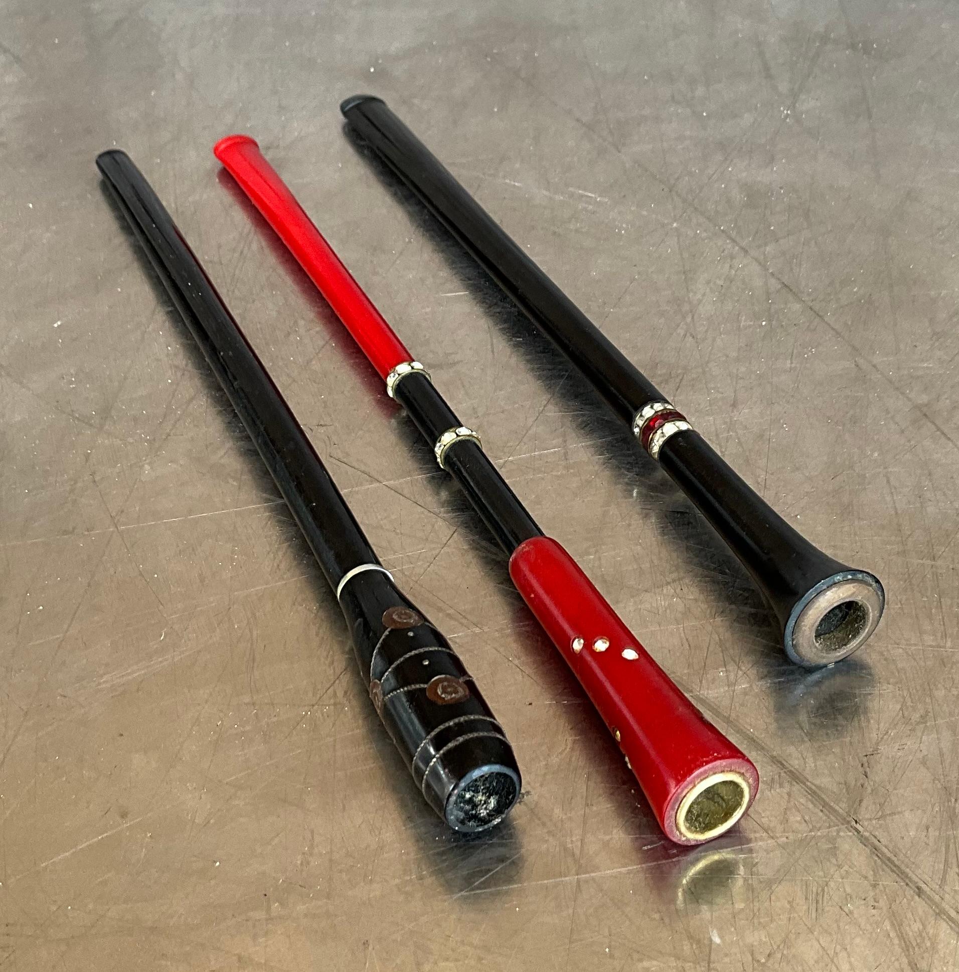 The Vintage Retro Cigarette Holder Set of 3 typically features a set of three holders, each designed to hold a cigarette in a stylish manner, keeping fingers away from smoke and ash. The holders often reflect the Retro or Art Deco aesthetic, with