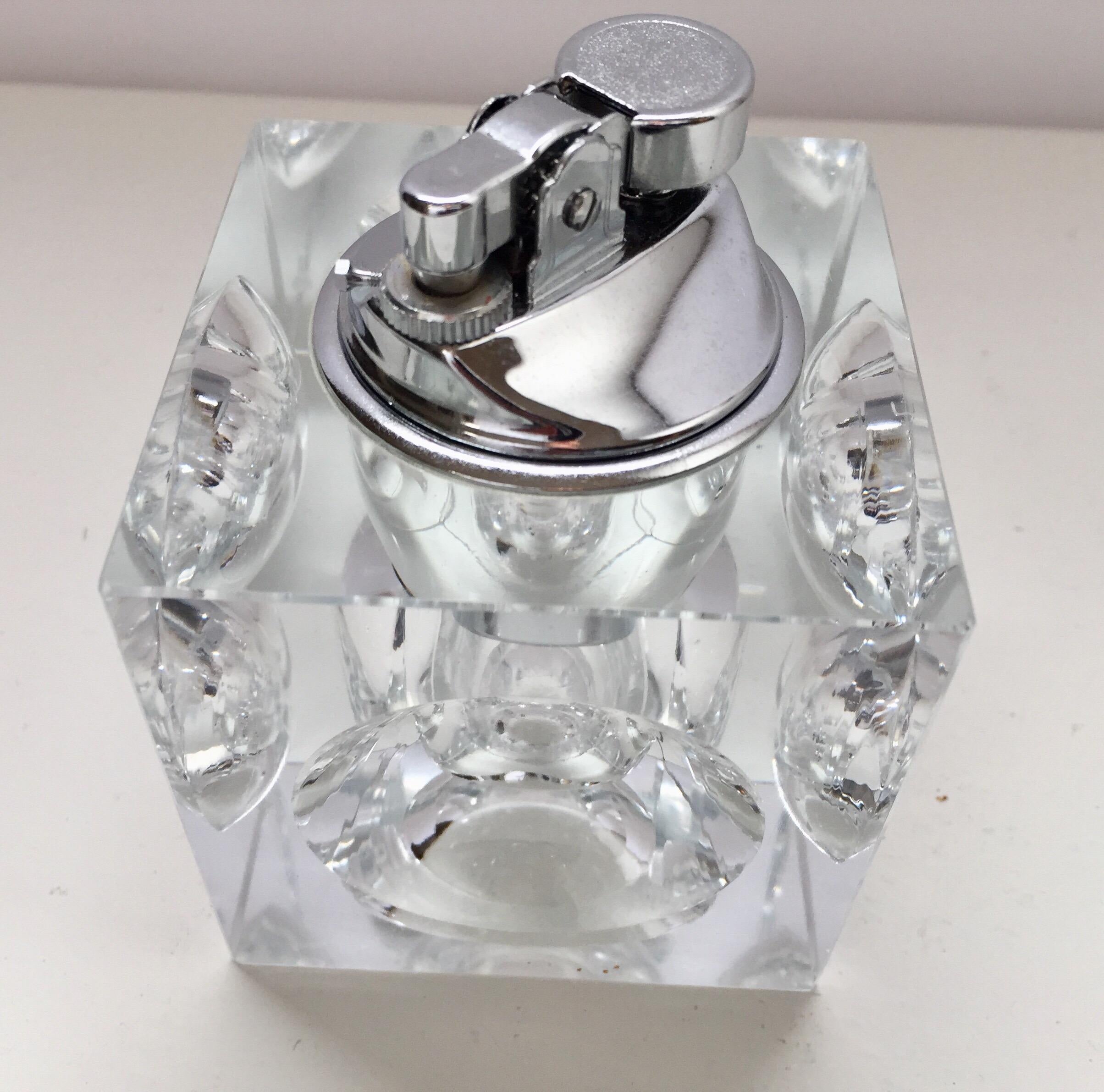 Vintage retro 1970s heavy cut glass cube table lighter-paperweight and ashtray.
Mid-Century Modern retro square glass lighter with circle cut dimples.
A dramatic accent to any modern living room decor, this square lighter and ash tray set will