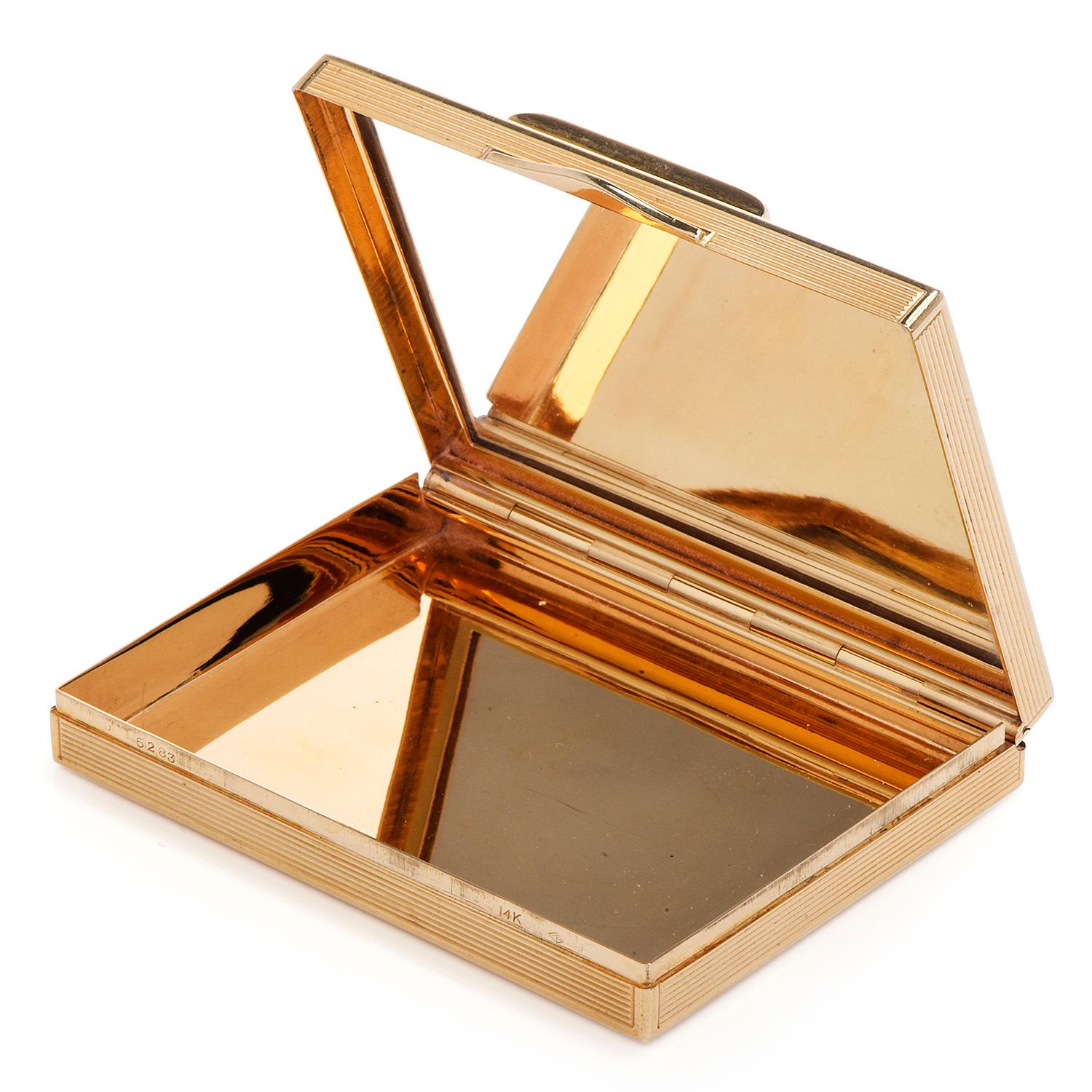 This vintage retro authentic compact Gold box, textured design with rubies & diamonds.

with an inner vanity mirror. it is crafted in solid 14K yellow gold, weighing 89.1 grams and measuring 2 3/4