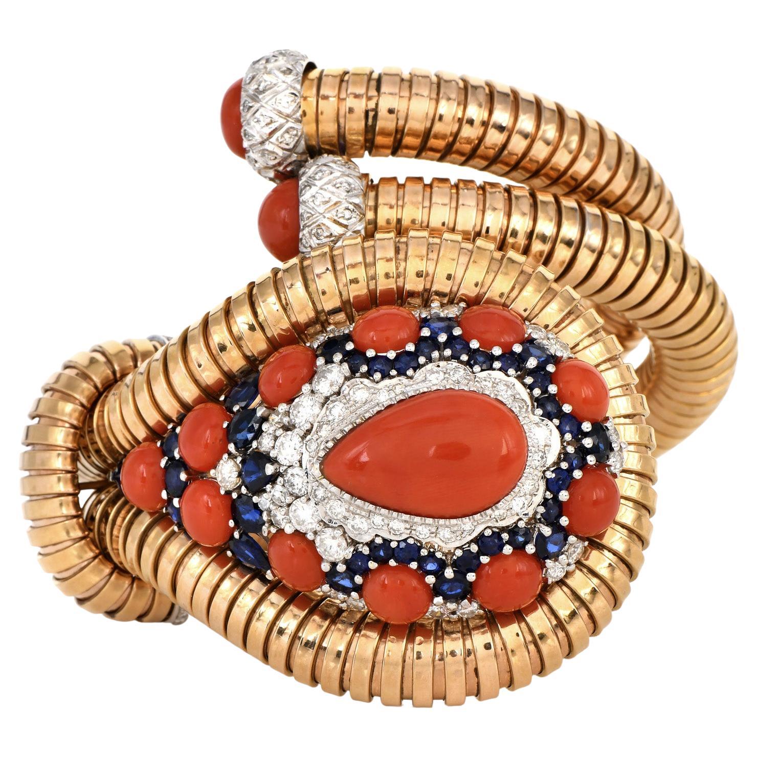 This magnificent double cuff 1950s bracelet is a show stopper inspired by the Cobra King Snake!

They are crafted in Solid 18K Rose Gold, 109.3 of total weight.

Enhanced by a cabochon pear cut, genuine Red Coral, in the center, adorned by 13