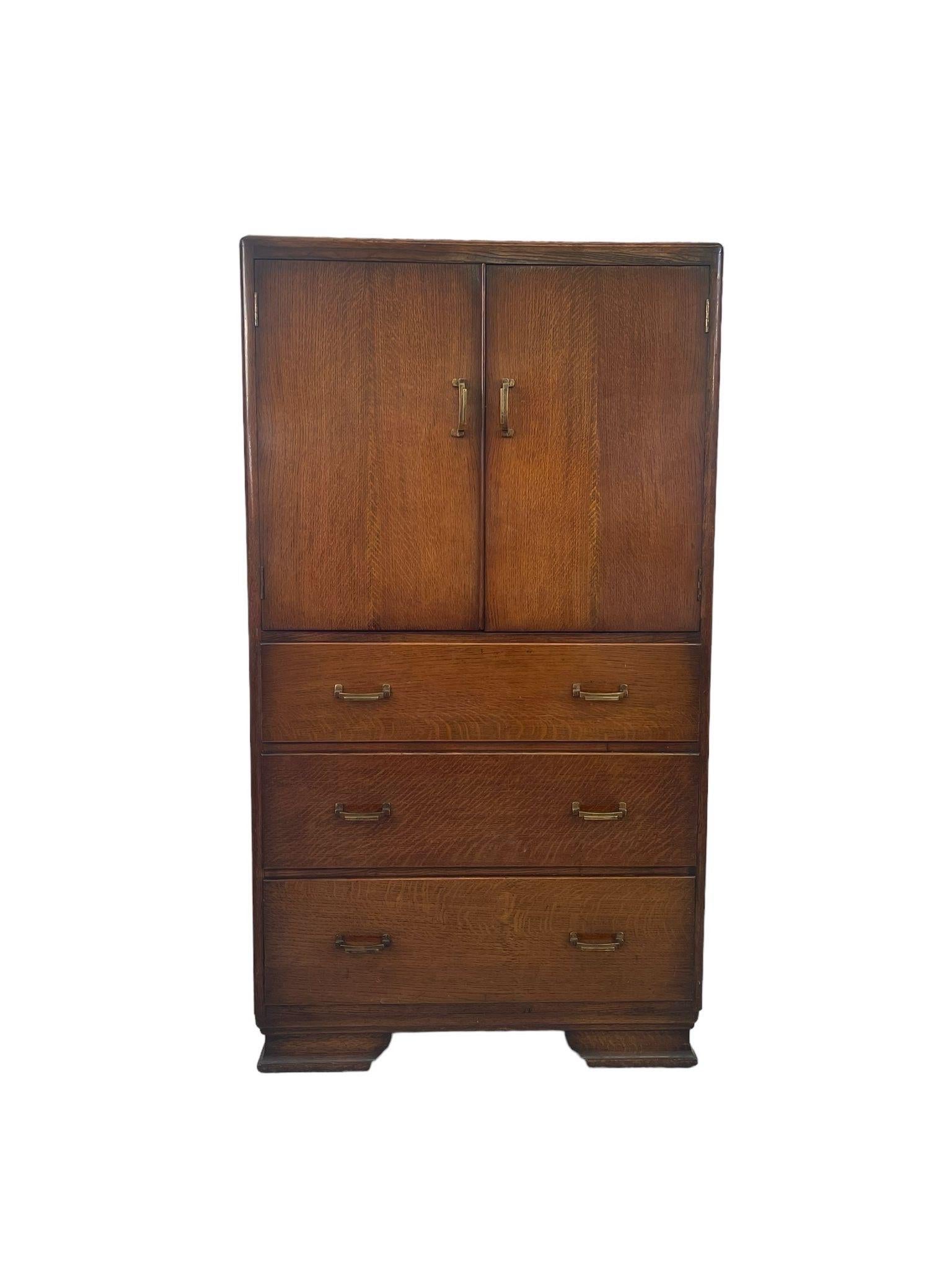 Vintage Dresser Possibly 1930s-1940s , the Style is of that Period. Three Drawers on the Bottom with a Cabinet Top. Brass Toned Hardware. Vintage Condition Consistent with Age as Pictured.

Dimensions. 30 W ; 18 D ; 54 H