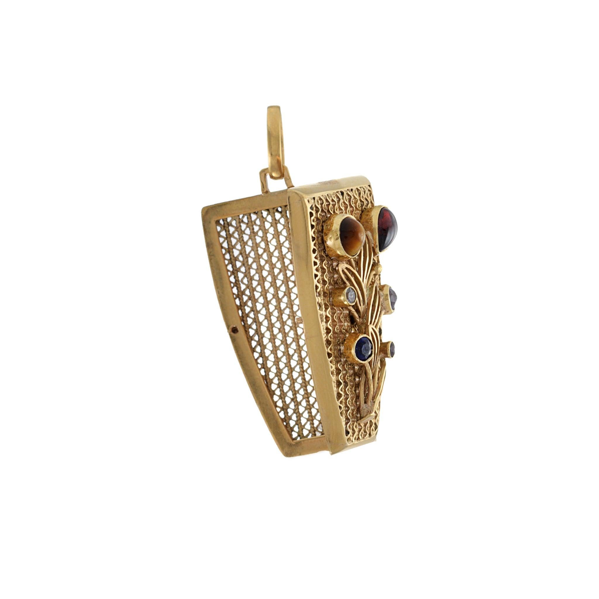 The pendant is crafted from 18KT yellow gold and features a variety of gemstones, making it a unique piece that will add a touch of vintage elegance to any outfit. With its intricate floral design and functional photo locket, this pendant is a