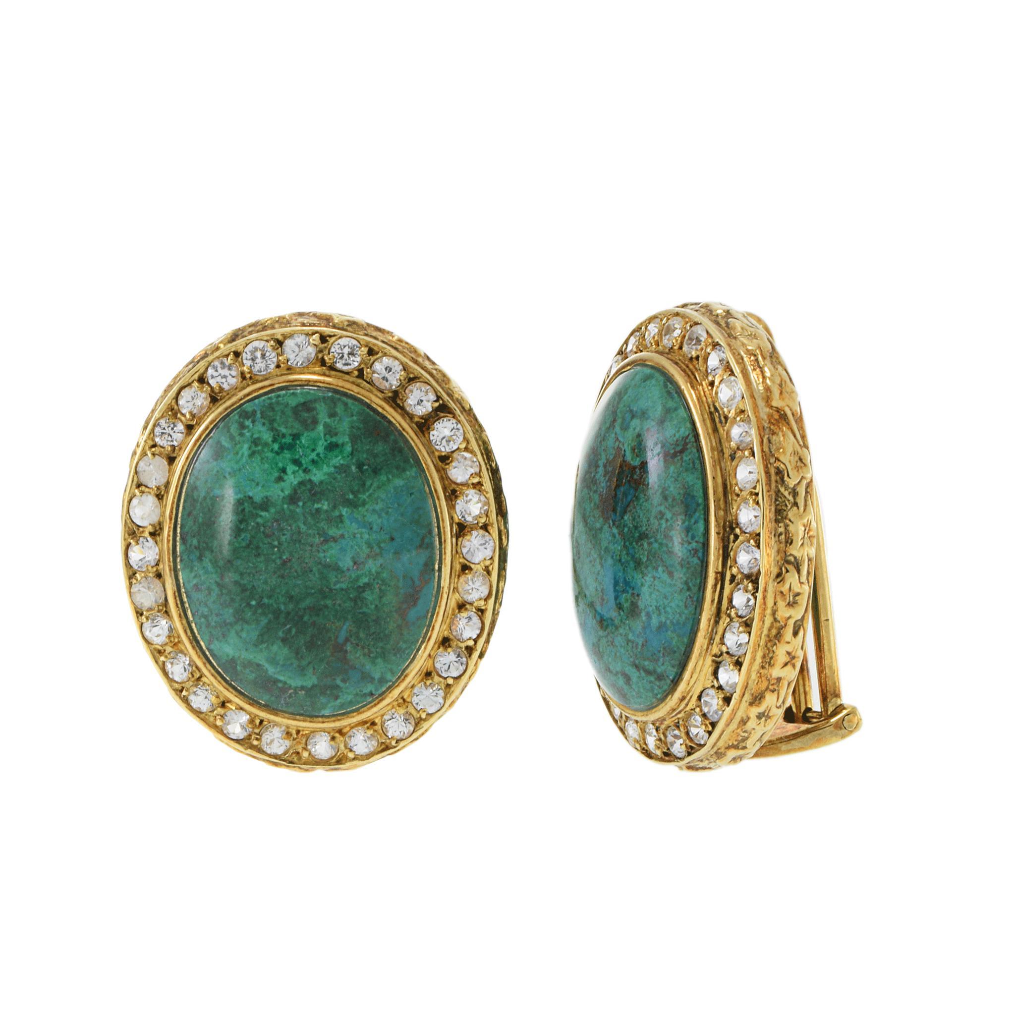 Step into the glamour of a bygone era with these stunning vintage earrings, crafted in rich 18KT yellow gold. Featuring large oval cabochons of deep azure malachite, each stone is encircled by a halo of sparkling white sapphires, totaling 3.00