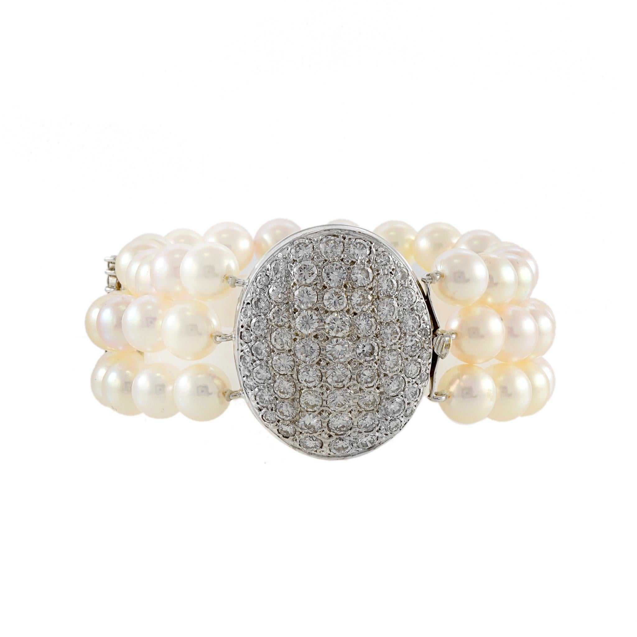 Indulge in the timeless elegance of our Estate Retro Era Three Row 7mm Akoya Pearl Bracelet. Each exquisite pearl is hand-selected for its perfect round shape and lustrous finish. The 14KT White Gold diamond clasp adds a touch of luxury with