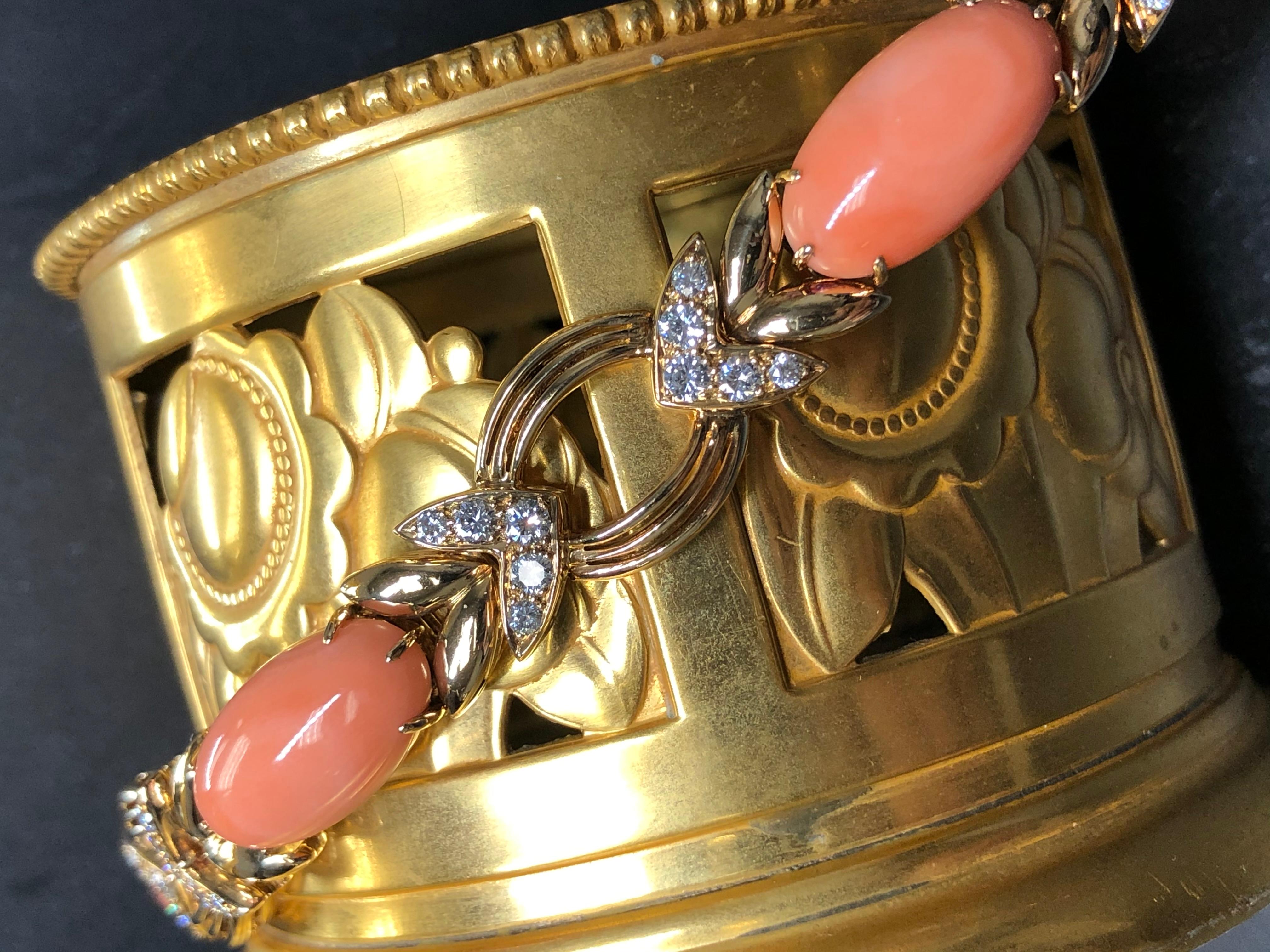 A spectacular piece done so well that of course it is French. It has been crafted in 18K yellow gold and prong set with perfect cabochons of pink coral separated by beautifully matched F-G color Vs round diamonds totaling approximately 2cttw. A