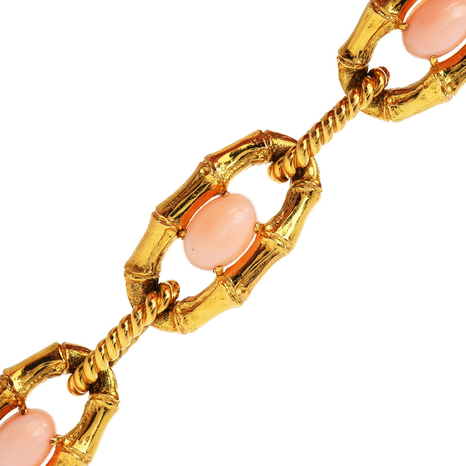 Elegant and unique, this is a high-quality link bracelet, made in France.

Exquisite textured with bamboo & rope link design, this vintage 1970s pink coral piece is crafted in solid 18K yellow gold.

Centered by 5 cabochons oval cut genuine pink