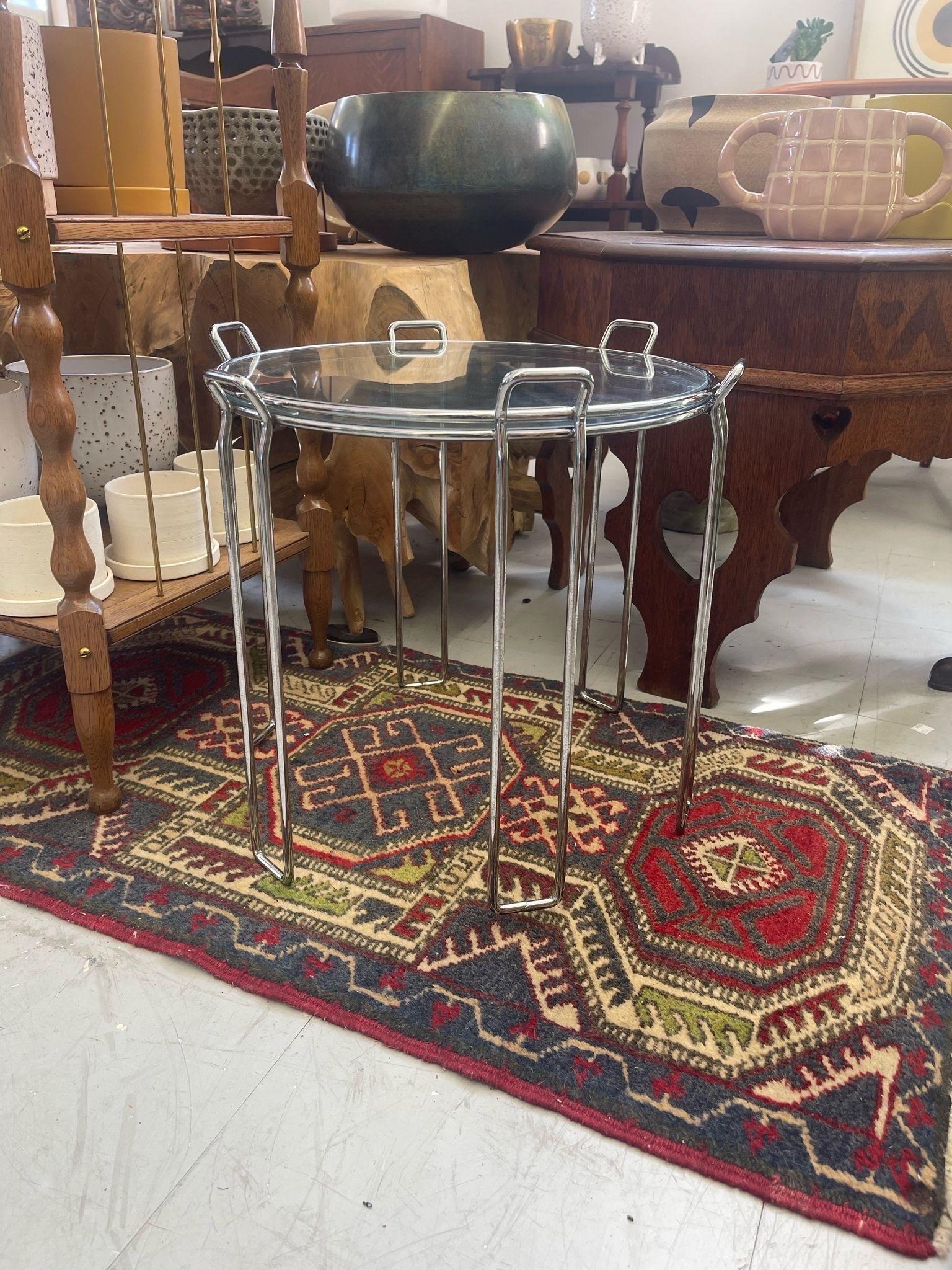 This pair of circular Nesting Tables has removable glass  trays. They sit on rectangular hairpin legs with tabs at the top. Made In Italy. Circa 1970. They rest on top of each other nicely with sleek design. Vintage Condition Consistent with Age as