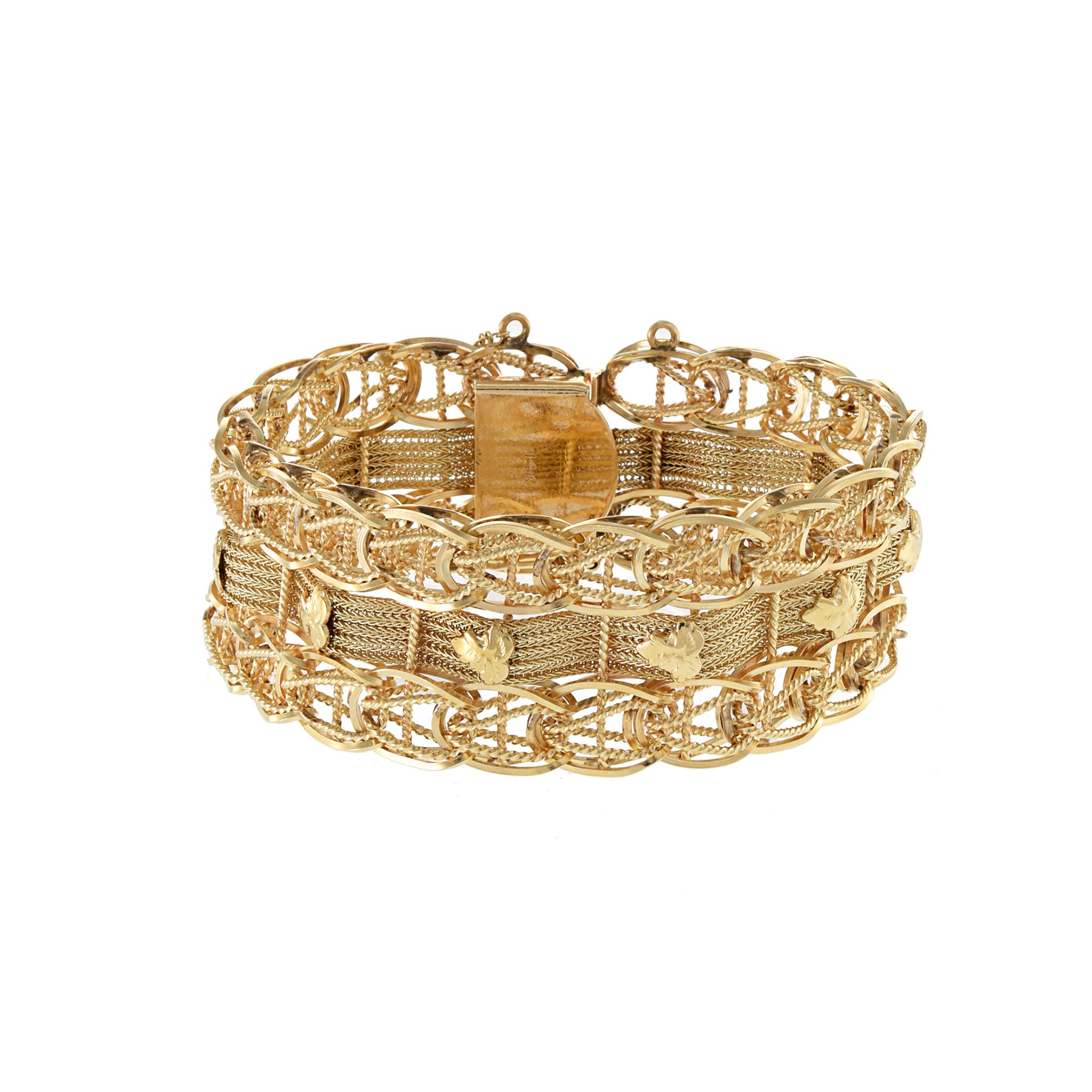 Sophisticated and elegant, this Estate Retro Period 14kt yellow gold bracelet boasts a wide mesh design accented with intricate gold leaf detailing. Weighing 56.49 grams, this luxurious piece is a true work of art for your wrist.
