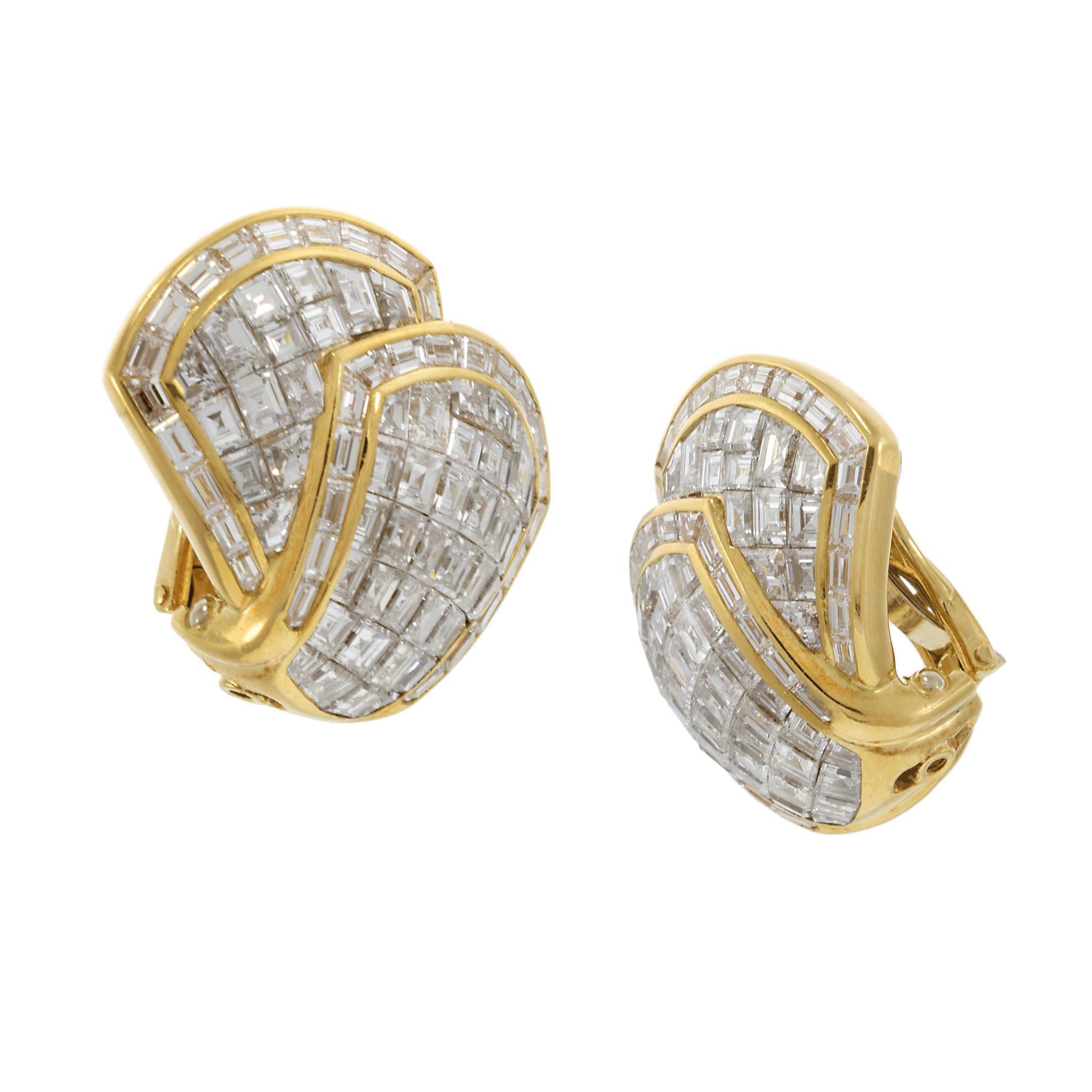 A stunning pair of vintage Retro period earrings, expertly crafted in 18KT yellow gold and featuring a dazzling 10.12CT-TW of F-VS mixed baguette-cut diamonds. The invisible setting creates a seamless, radiant display of brilliance, enhancing the
