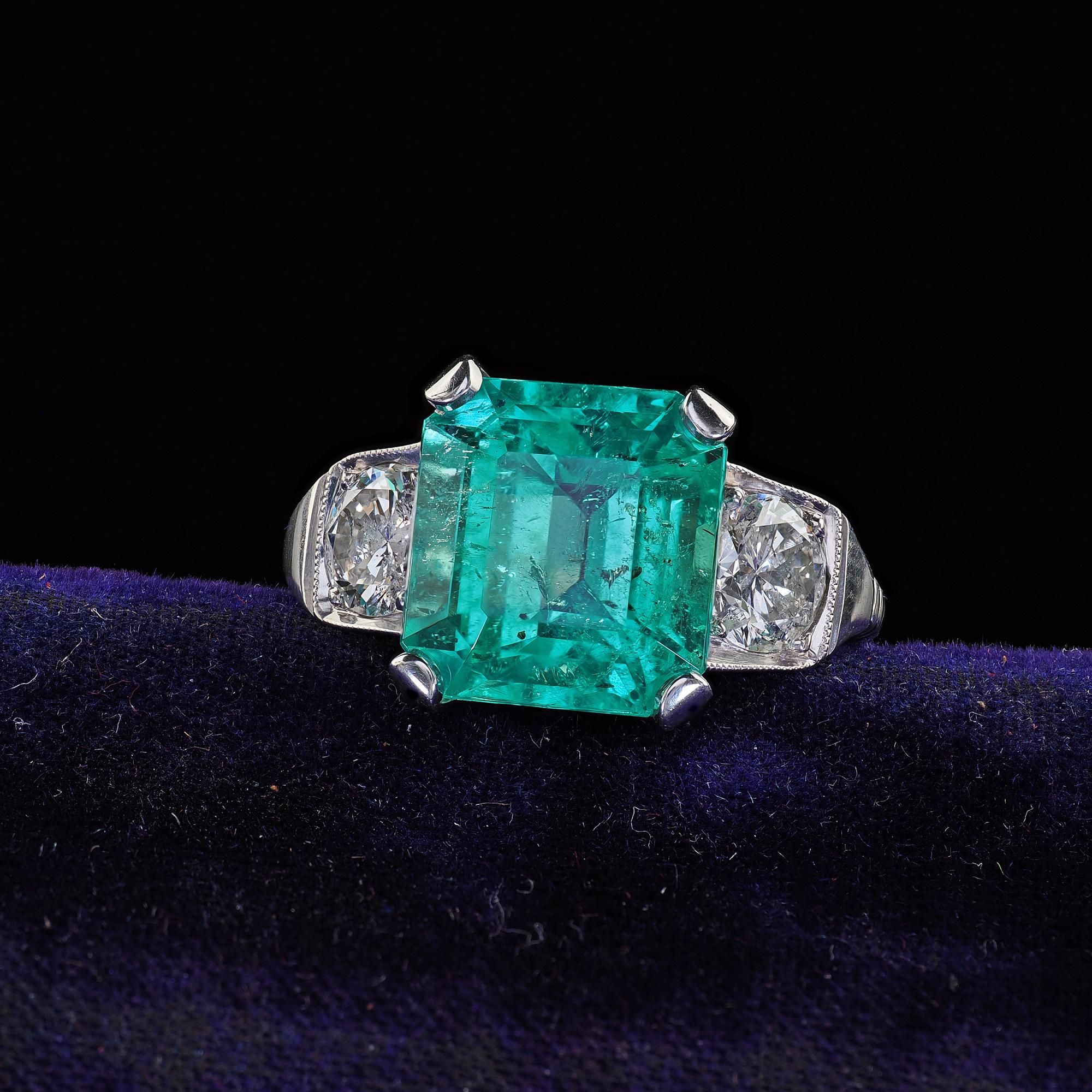 Beautiful Vintage Retro Platinum Colombian Emerald and Diamond Engagement Ring - GIA. This gorgeous Retro Colombian emerald and diamond engagement ring is crafted in platinum. The center holds a beautiful bright green Colombian emerald that has a