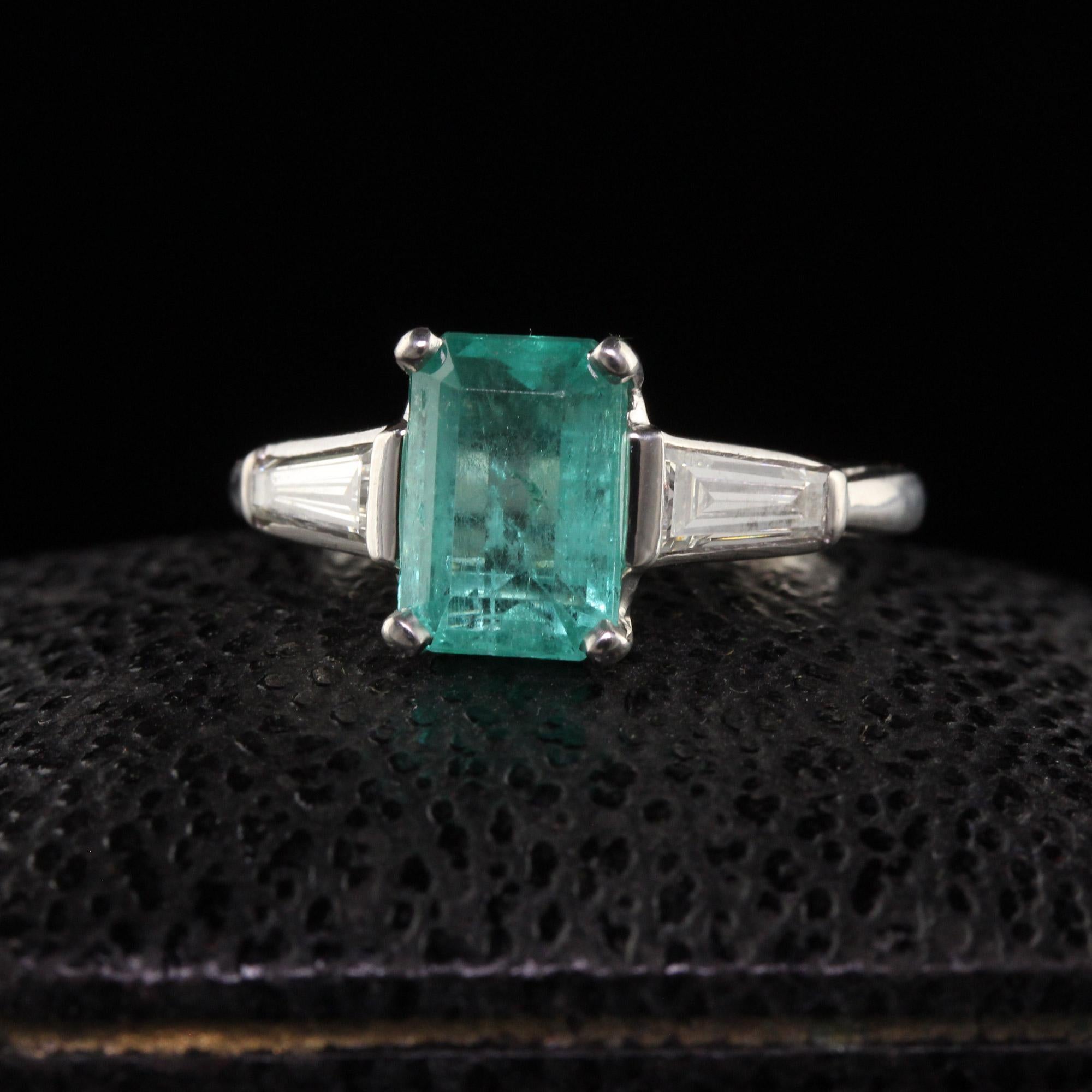 Beautiful Vintage Platinum Colombian Emerald Diamond Baguette Engagement Ring. This beautiful engagement ring is crafted in platinum. The center holds a natural colombian emerald and has large baguette diamonds on each side. The emerald is a