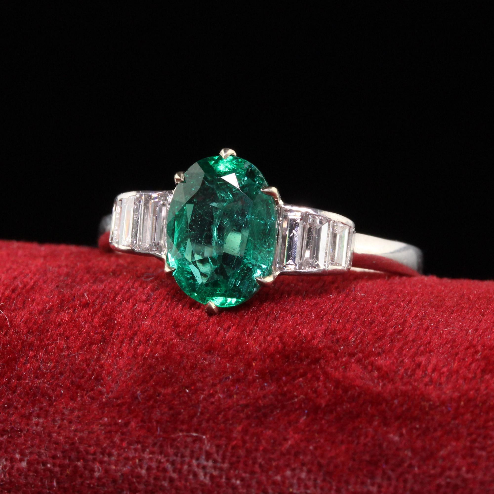 Beautiful Vintage Retro Platinum Natural Emerald and Diamond Engagement Ring. This gorgeous engagement ring is crafted in platinum. The center holds a natural oval cut emerald with a deep green saturation of color. The sides are custom cut baguettes