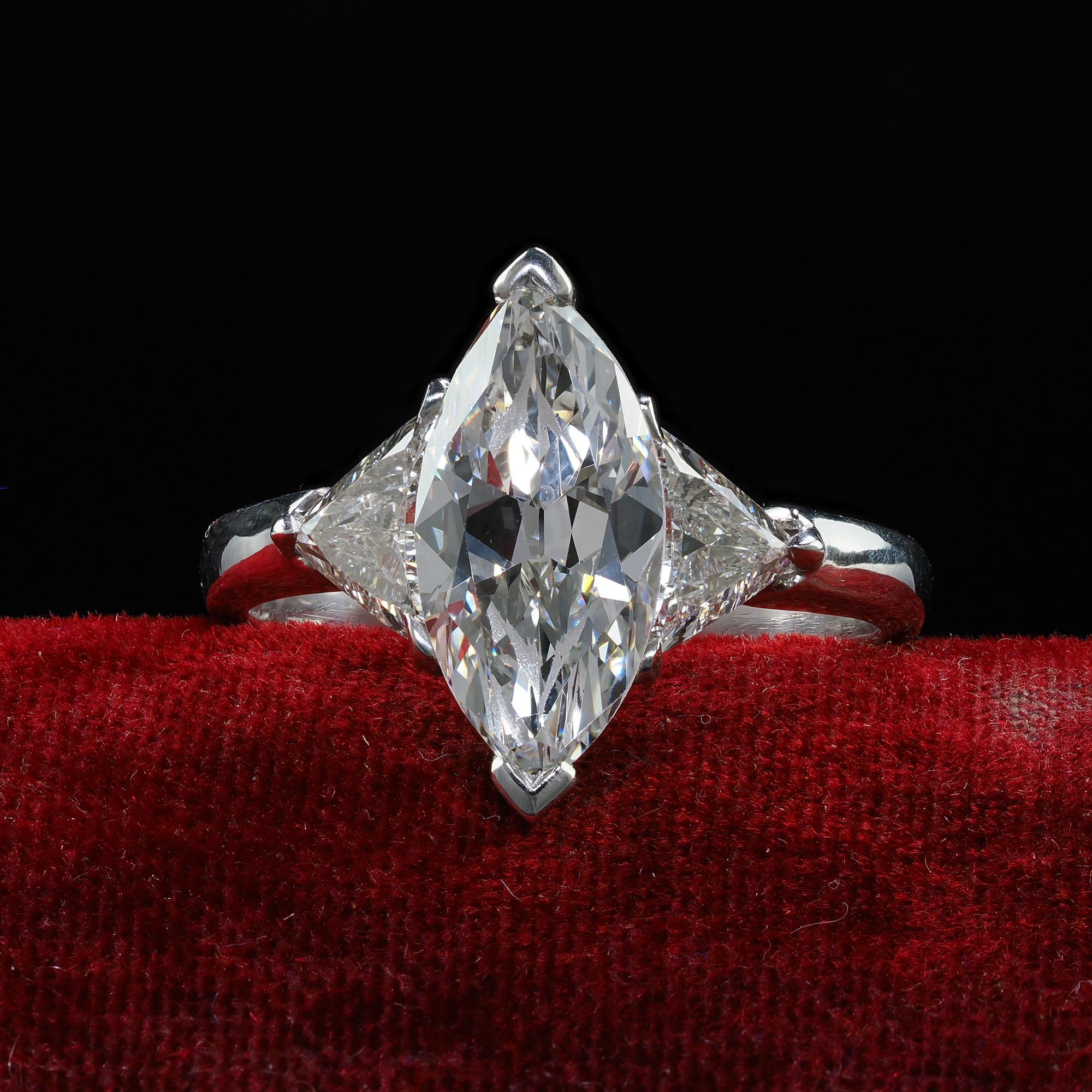 Beautiful Vintage Retro Platinum Old Marquise Trillion Cut Diamond Engagement Ring - GIA. This gorgeous retro diamond engagement ring is crafted in platinum. The center holds a beautiful old cut marquise diamond in the center that has a GIA report.