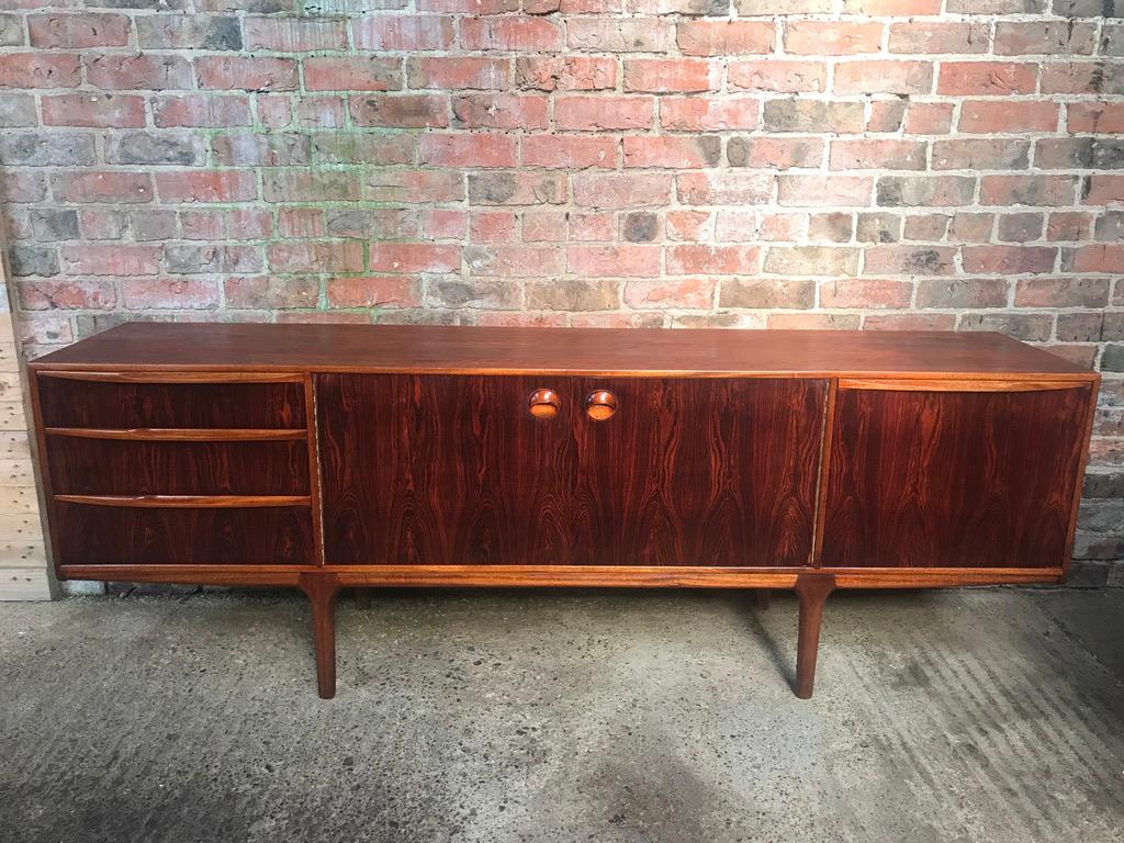 Vintage 1960s McIntosh sideboard by Tom Robertson for Mcintosh, this is one of the best ones around! It has three drawers, cupboard space with lovely round handles, and a drinks section with a useful pull-out shelf. Have a look at the beautiful wood