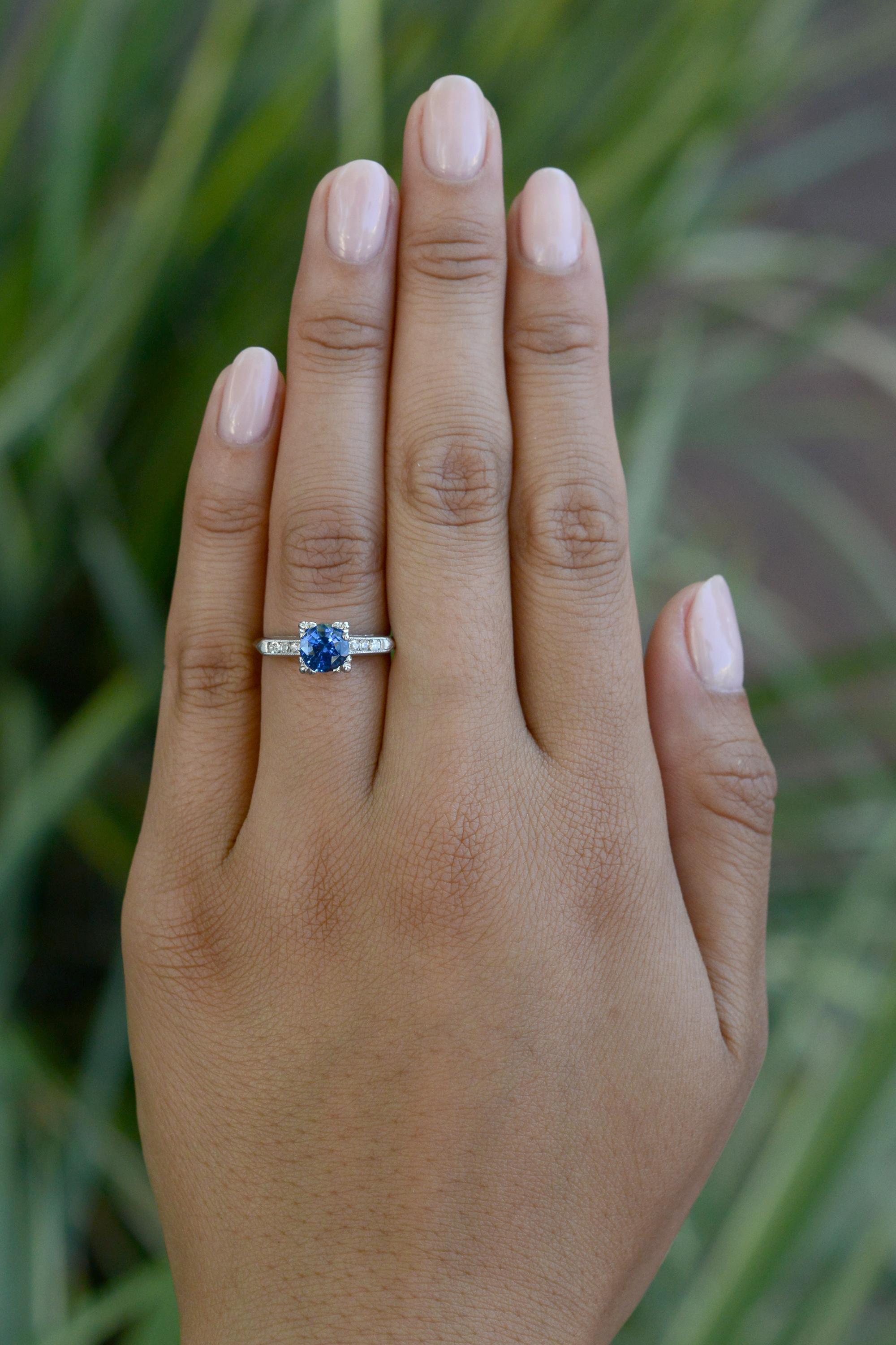 An authentic retro gemstone engagement ring, circa 1940s. This vintage heirloom features a lovely, rich, velvety-blue sapphire solitaire of 1.25 carats perched in enduring platinum. The supreme craftsmanship percolates with a sumptuous knife edge