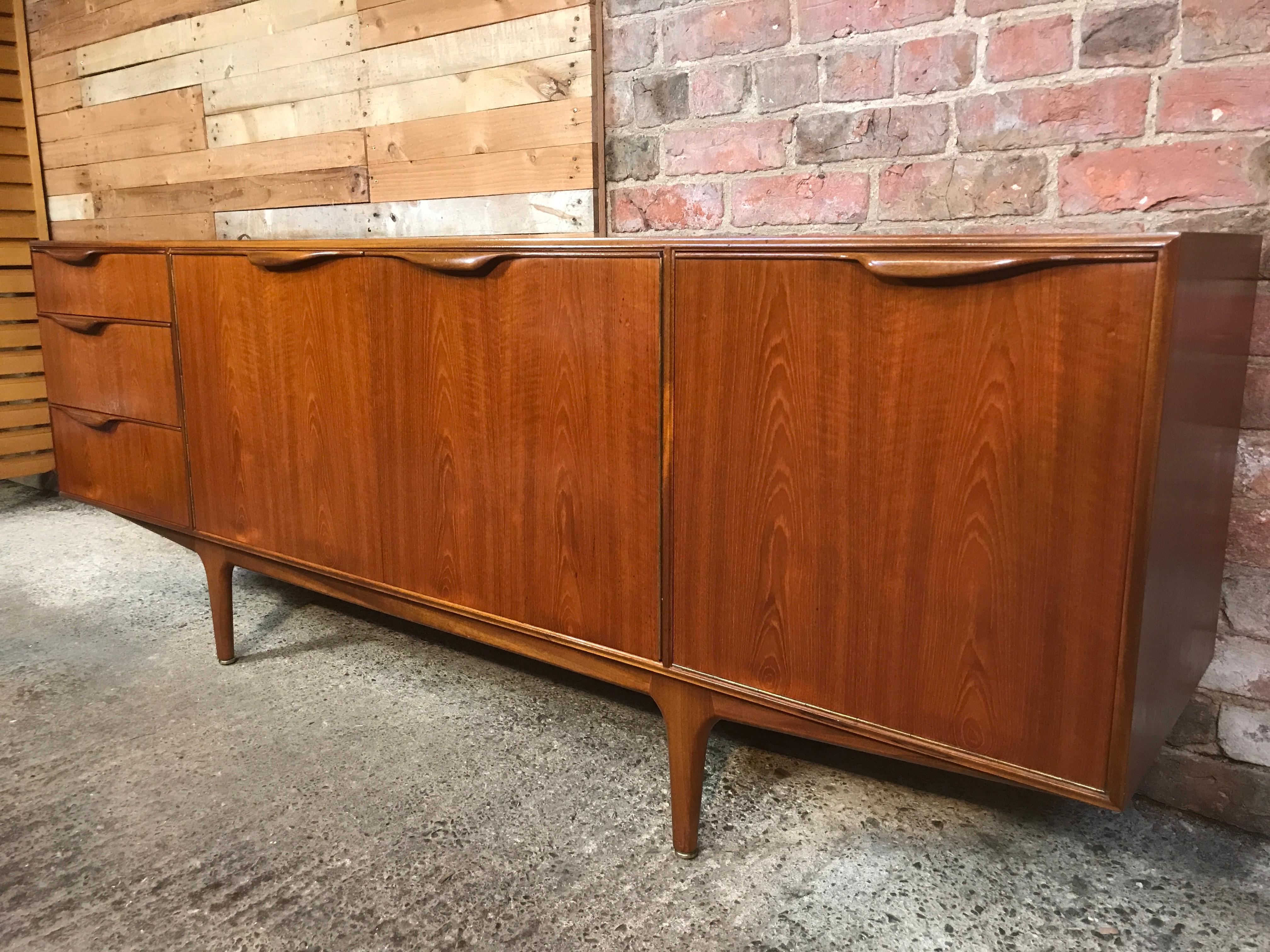 Vintage 1960s McIntosh sideboard by Tom Robertson. It has three drawers, cupboard space, and a drinks section with a useful pullout shelf. Credenza is in very good original condition.